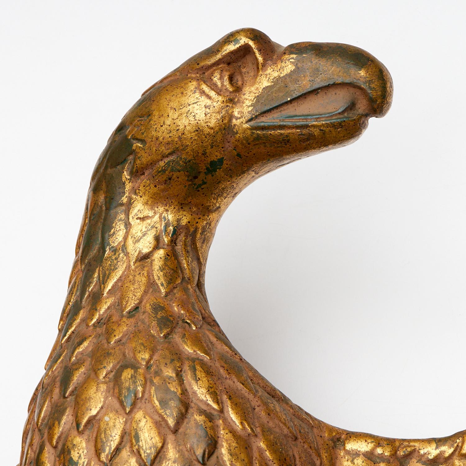 19th c., Americana, a large scale gilt and forest green painted cast plaster eagle, depicted spread-wing, with crisply detailed overlapping feathers. With mounting bracket on reverse. This is a very handsome example of an iconic form. The