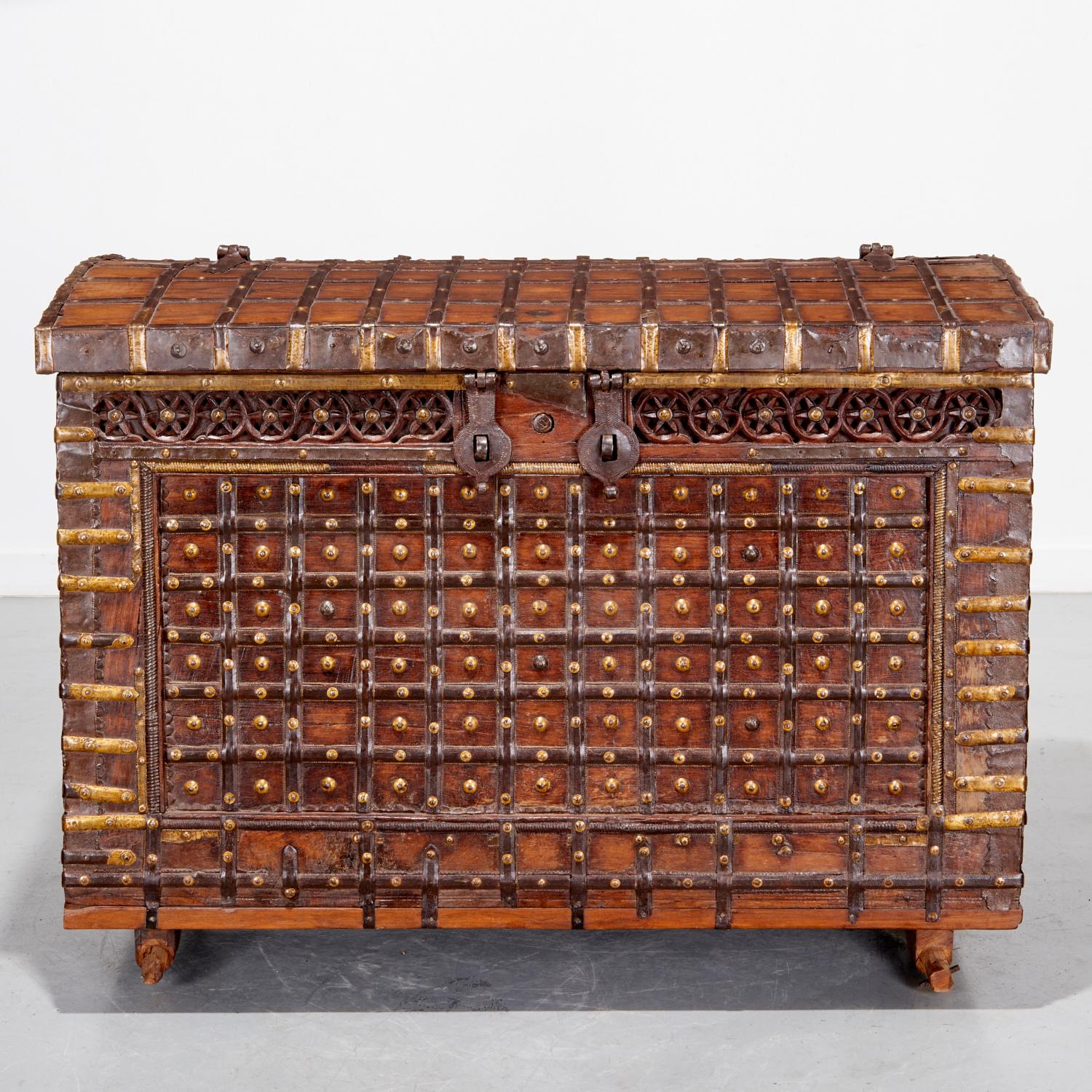 A large antique traditional Indian coffer known as a Pitara Chest, meaning Treasure Chest (or more literally ‘a box full of treasures’ in Hindi). 19th c. or earlier, with hammered copper elements, on skid base.

Pitara chests were traditionally used