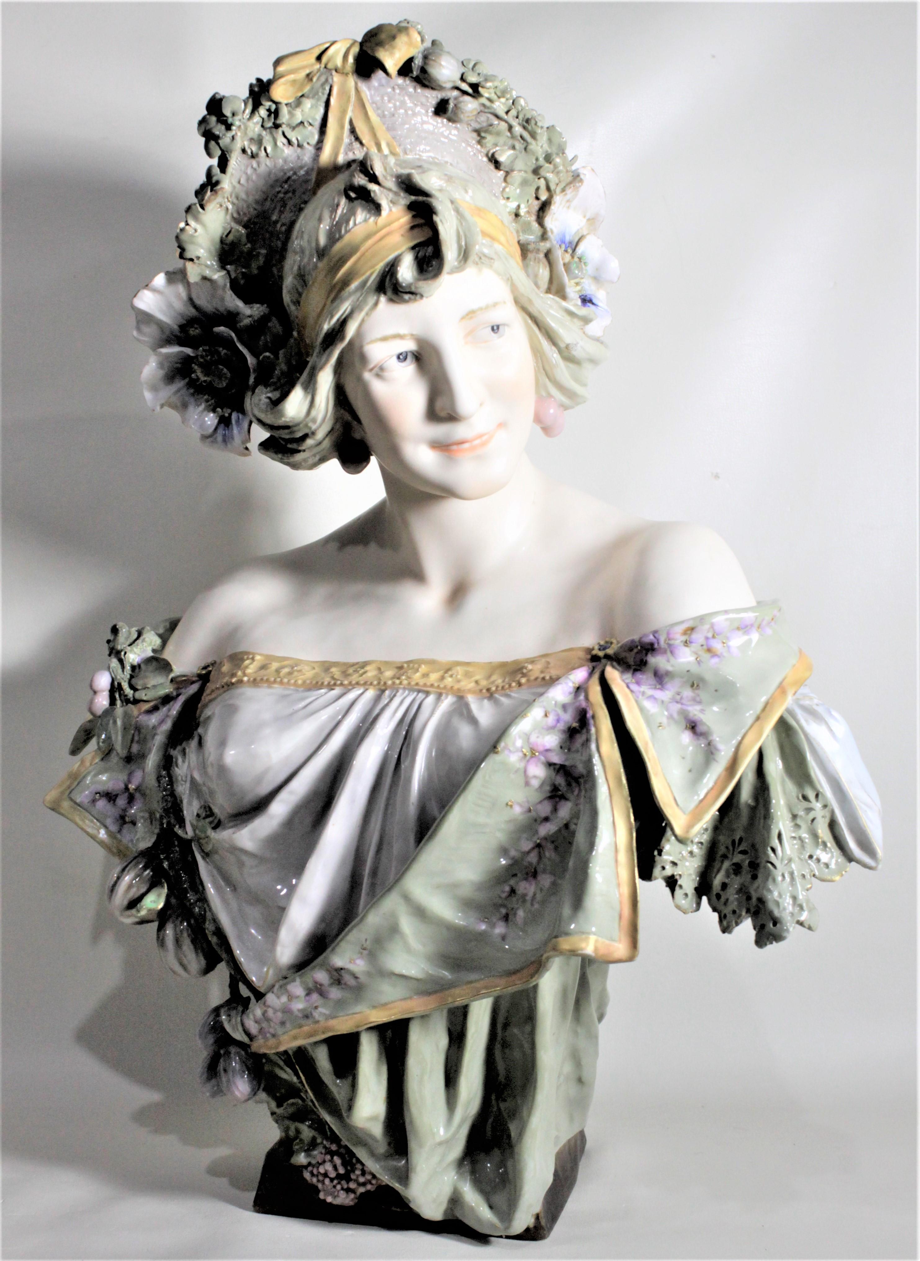 This large and very well executed antique porcelain bust is presumed to have been made in Austria in circa 1890 in the period Art Nouveau style. The bust does have a very faint and illegible signature on the rear of the base, but the artist could