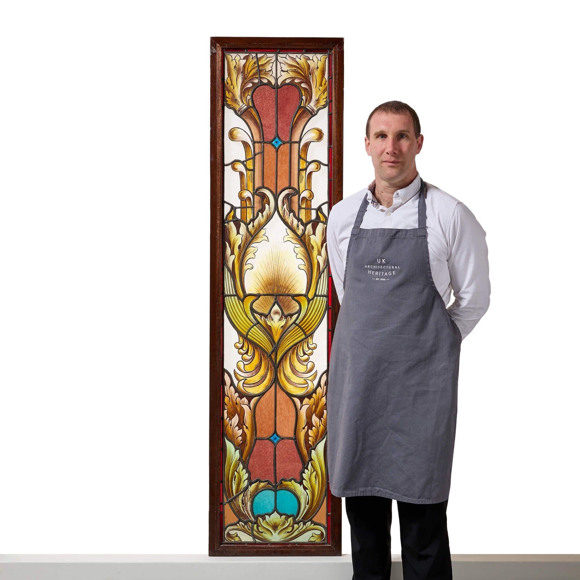 A large antique art nouveau style stained glass in an original mahogany frame.

Dating to circa 1890, this panel showcases a hand painted design of scrolling foliage and organic patterns, evoking talent of its 19th century artist and their