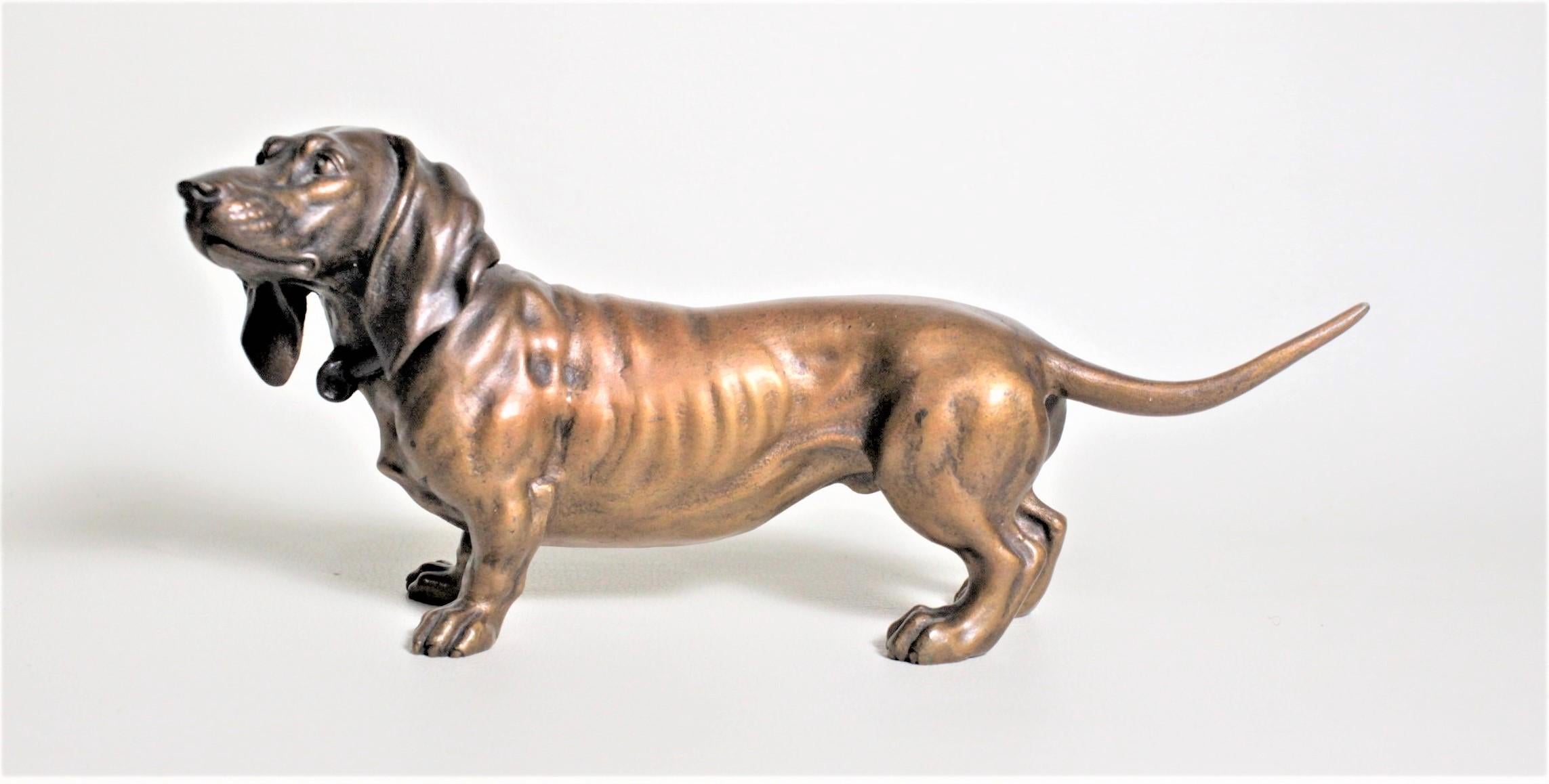 This antique cast and cold-painted bronze sculpture is unsigned but presumed to have been made in Austria in circa 1900. This well executed cast bronze study depicts a basset hound in a very realistic and detailed manner from all sides which has
