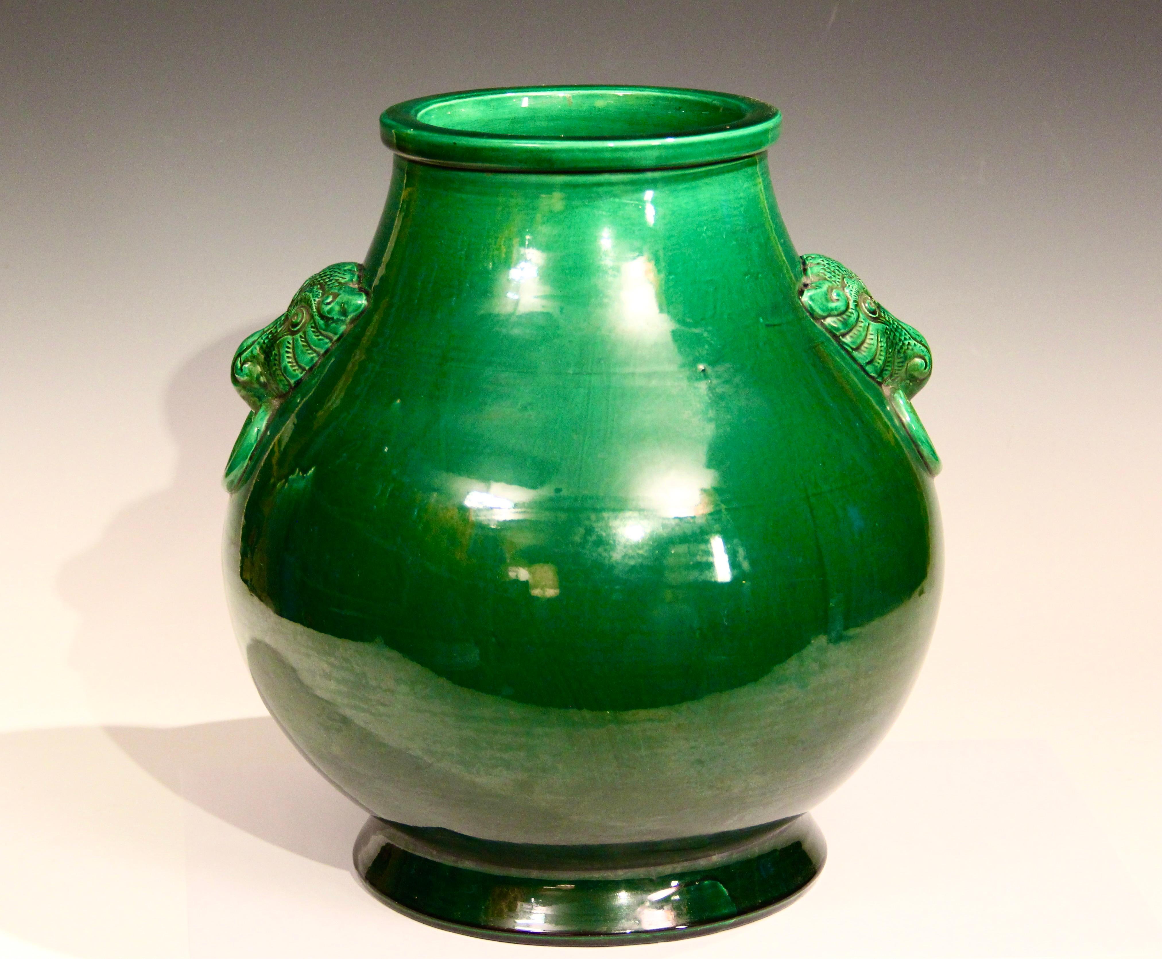Large Awaji Hu form vase in deep green glaze, circa 1910. Inspired by an ancient Chinese bronze form with fantastic taotie mask handles. Measures: 13 1/2