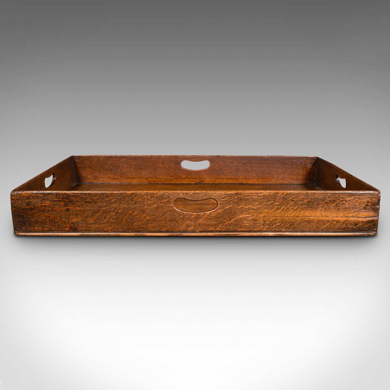 This is a large antique baker's tray. An English, oak butler's serving tray, dating to the Georgian period, circa 1750.

Superb proportion and figuring to this delightful Georgian tray
Displays a desirable aged patina and in good order
Oak stocks