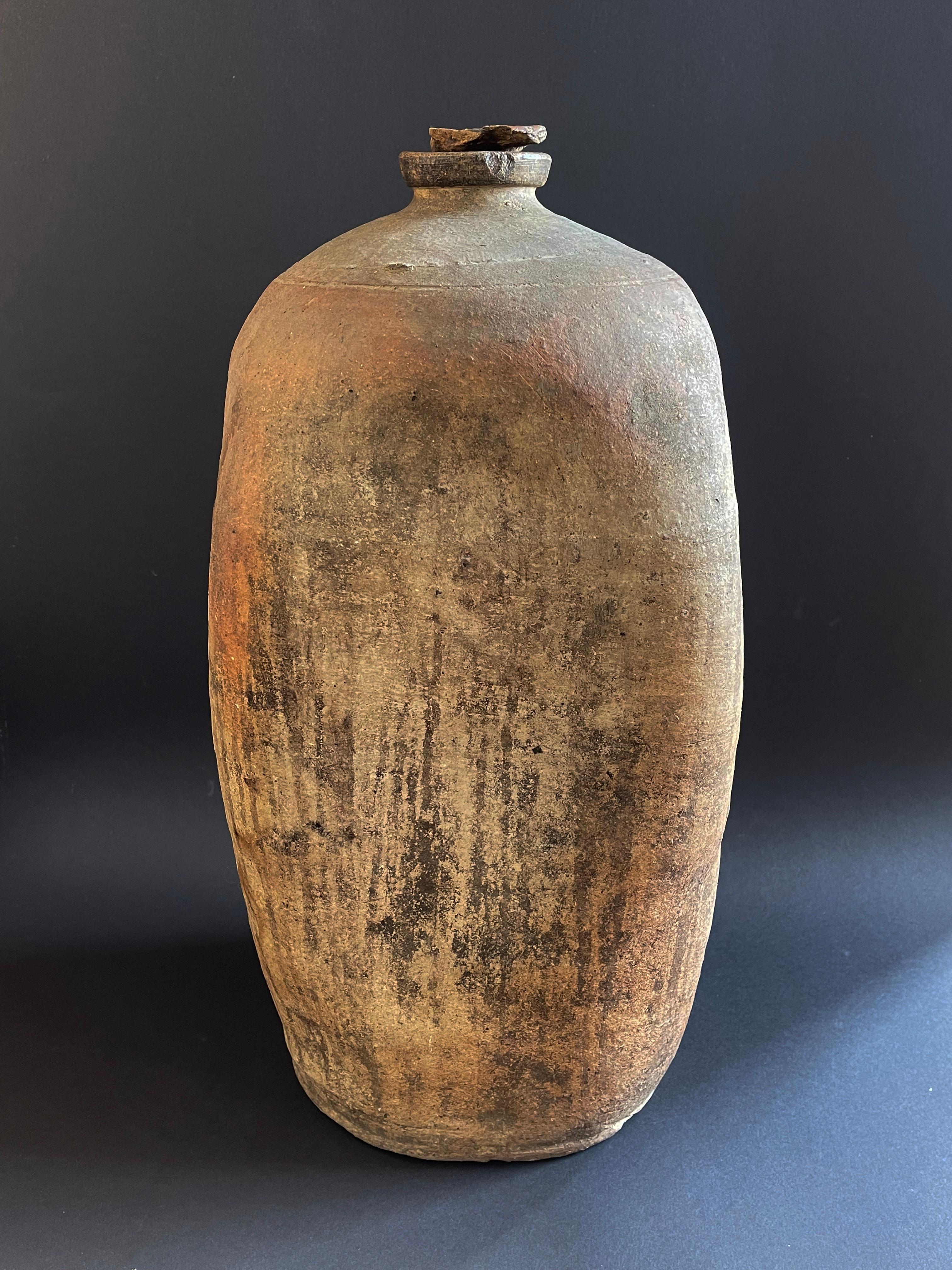 Antique hand crafted and unique stoneware jug with a square belly and round base. The jug comes with a round screw cap.
Possibly Balkan area or Italy, around 1800s to 1900.
Beautiful burnt clay vessel, which was used to store (and make) plum