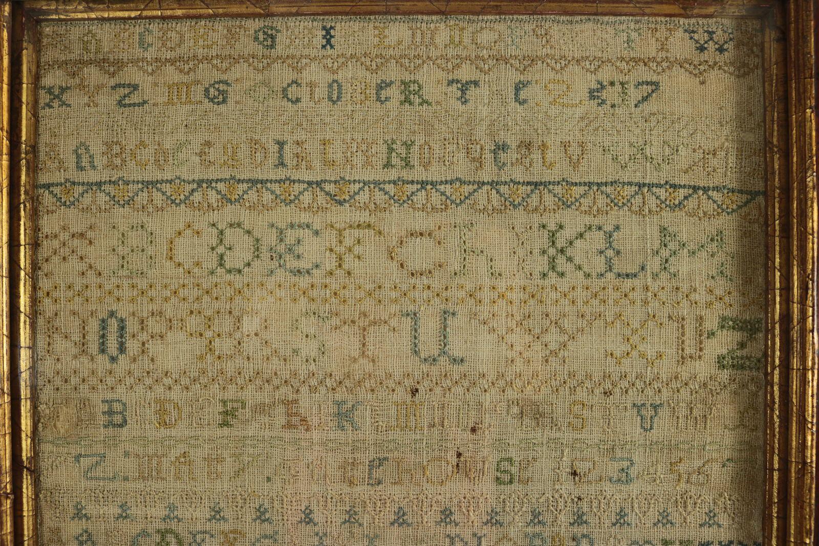 Large Antique Band Sampler, c.1725, by Mary Gatehouse. The sampler is worked in silk on a linen ground, in a variety of stitches. No border, divider lines in various patterns. Colours blue, light brown, green and gold. Alphabets A-Z in upper case