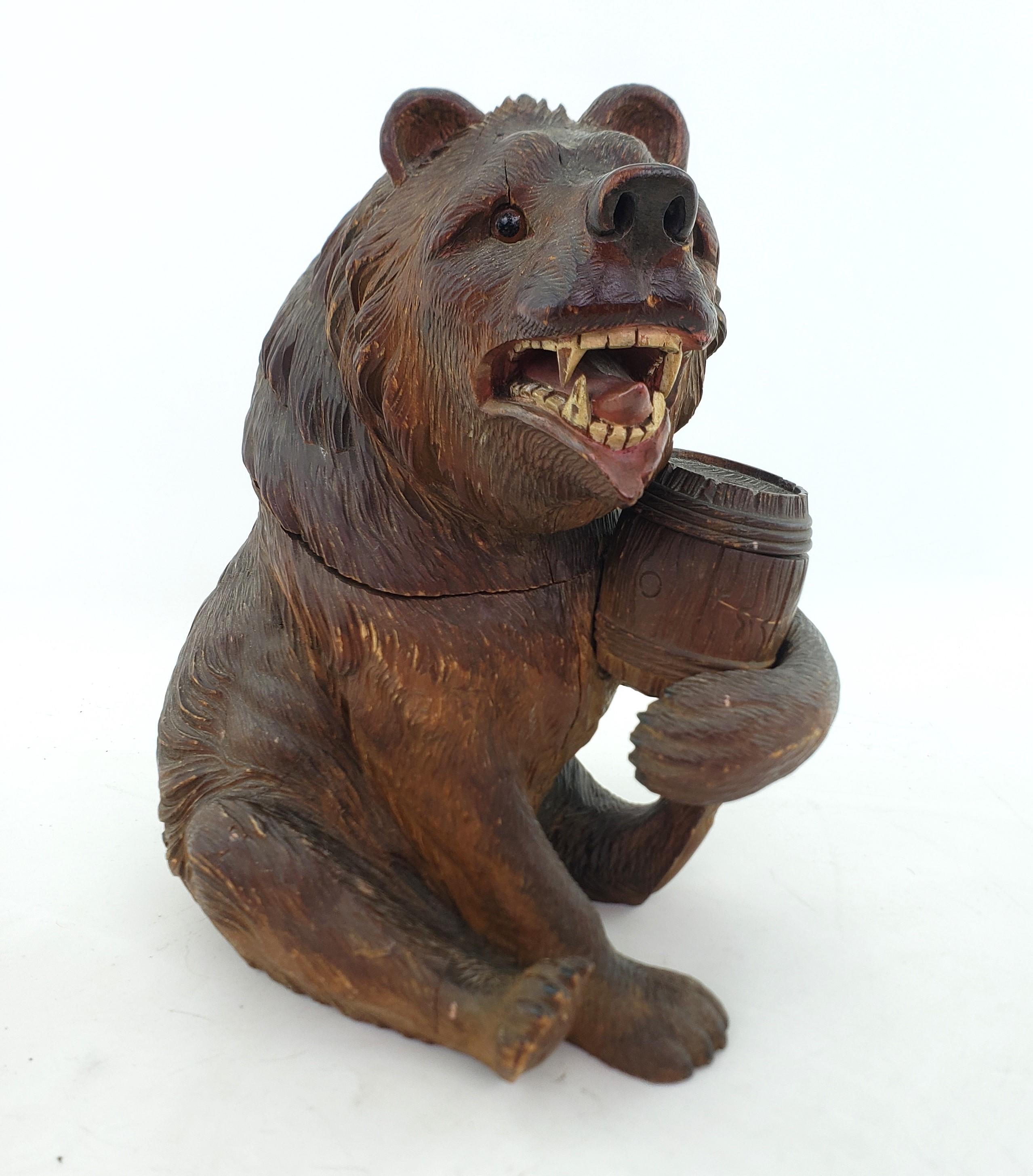 This large antique humidor is unsigned, but presumed to have originated from Austria and date to approximately 1900 and done in the period Black Forest style. This well executed sculptural humidor is done in pine and depicts a very angry bear