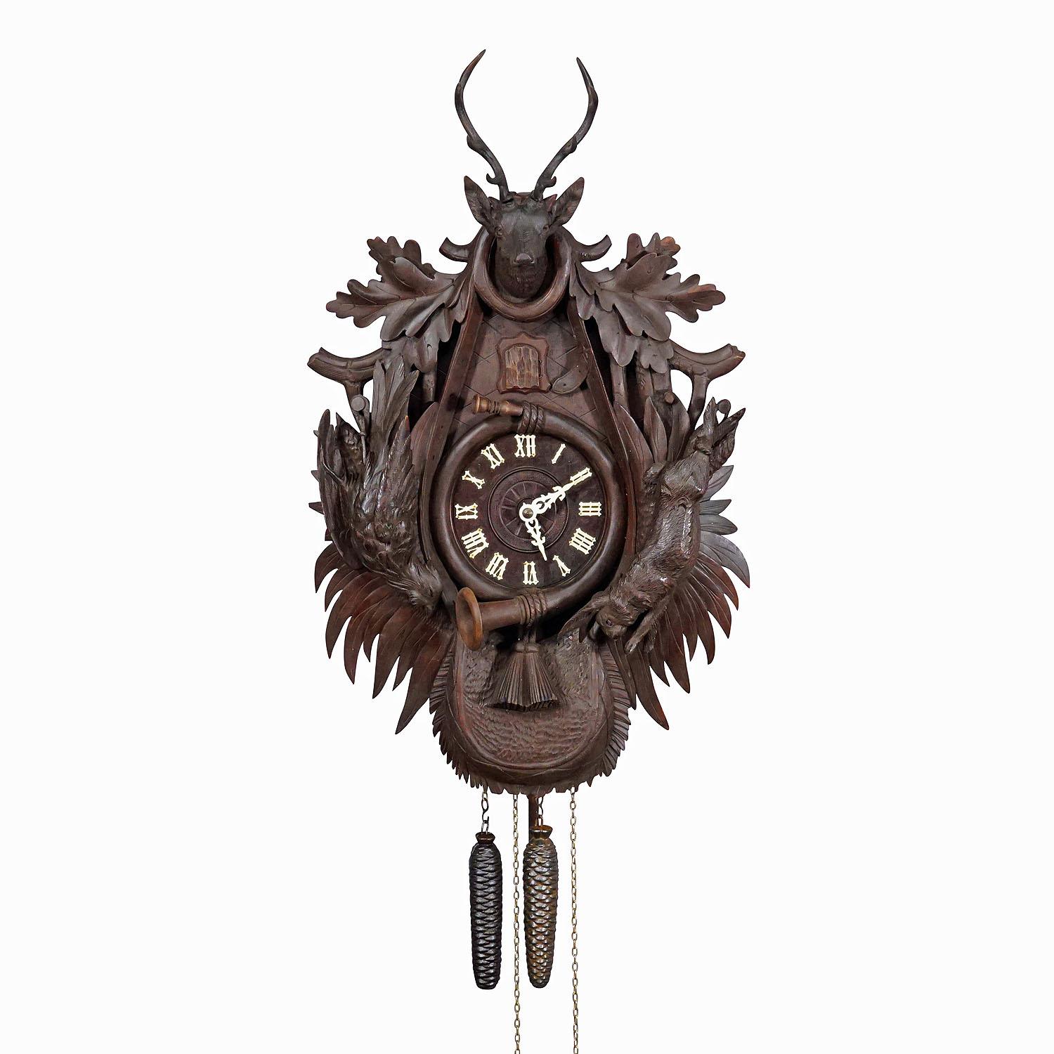 Large Antique Black Forest Carved Cuckoo Clock with Stag Head

A large handcarved wooden cuckoo clock, decorated with hunting accessoires, oak leaves, hare, pheasant and a stag head on top. Black Forest, Germany ca. 1900. Clockwork in working