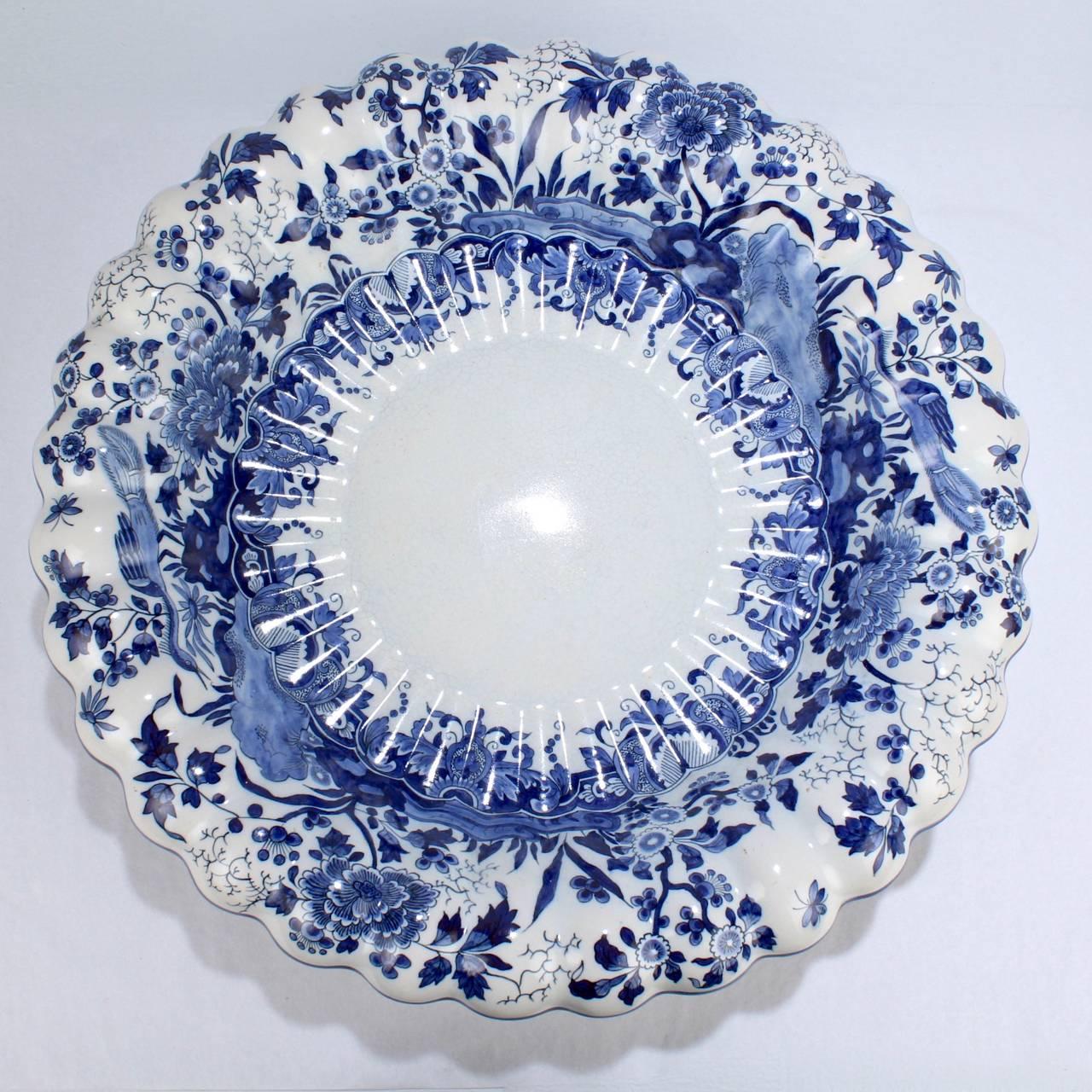 A good ribbed Delft bowl

With scalloped border and blue chinoiserie decoration to the lobed rim.

The base bears a blue underglaze factory mark and impressed numbers.

Diameter: ca. 14 1/4 in.

Items purchased from this dealer must delight