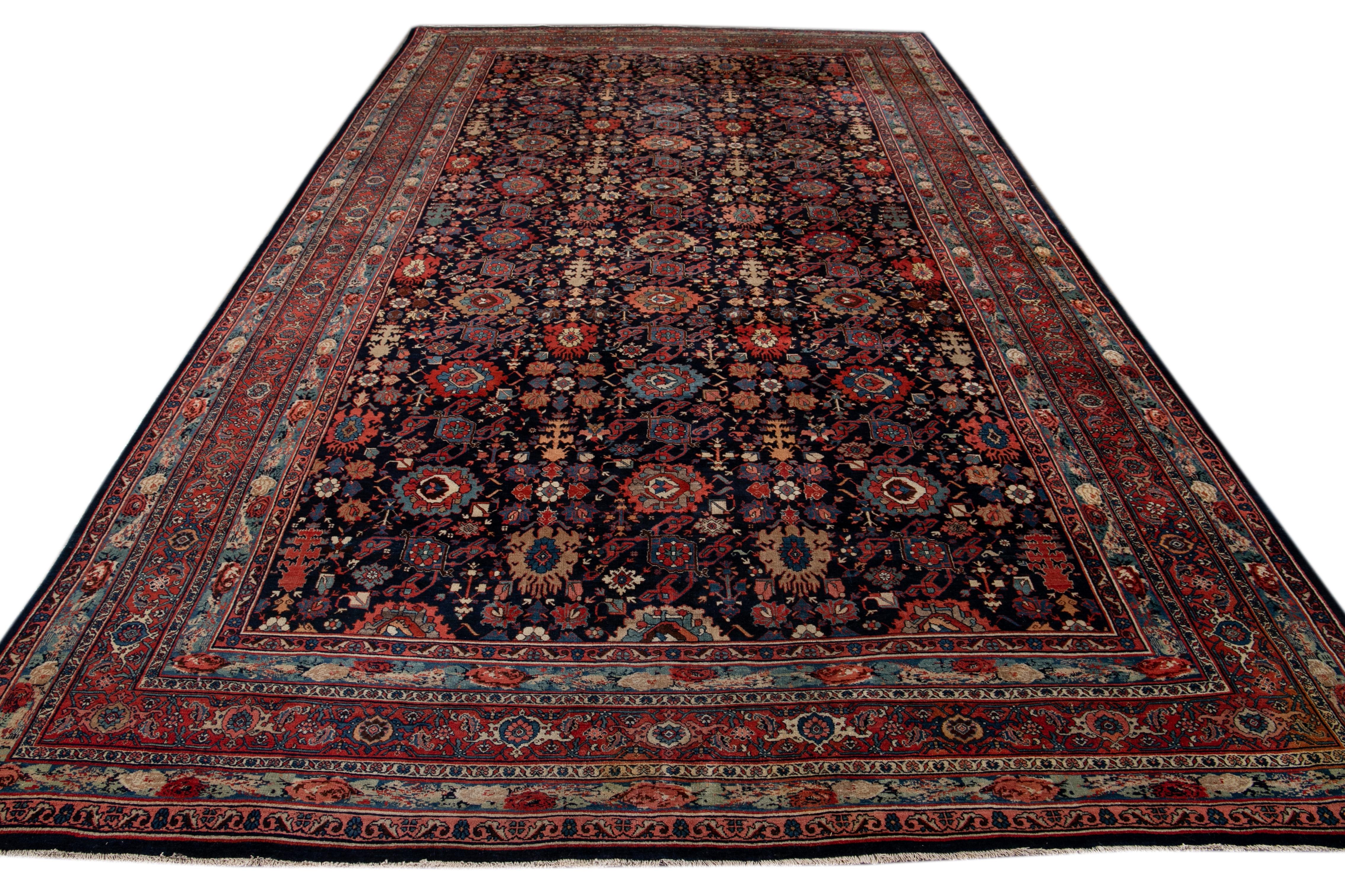 Beautiful antique Oversize Bidjar hand knotted wool rug. This rug has a navy-blue field with a traditional multicolored medallion design. This rug also features a multicolored red border,

This rug measures 10' 3