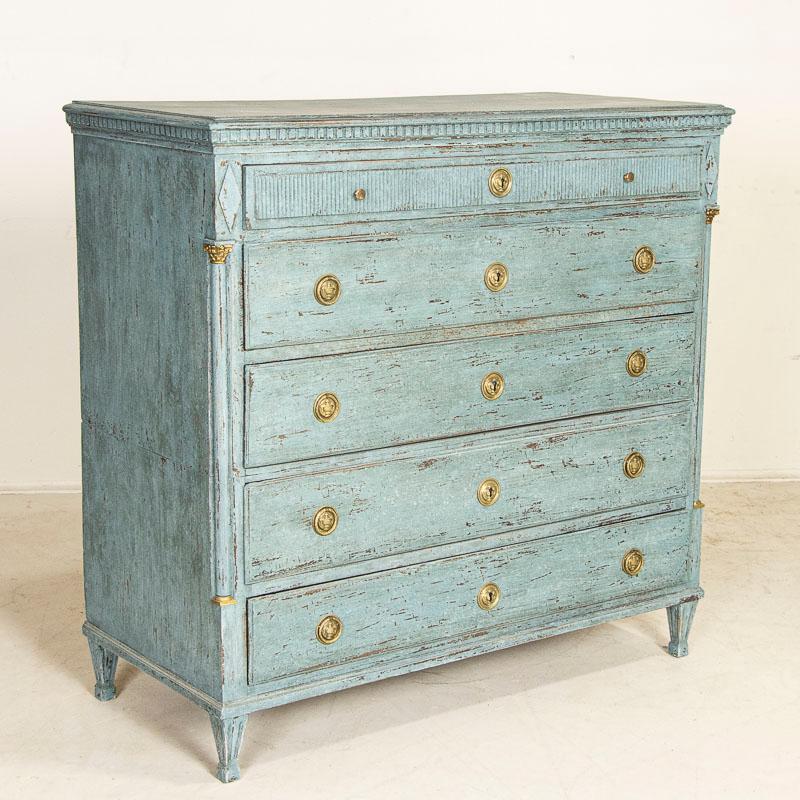 The deep blue painted finish is captivating in this large oak chest of drawers. Please examine close up photos to appreciate the multiple layers of blue and cream paint including areas of distress revealing the natural oak below. Unique to this