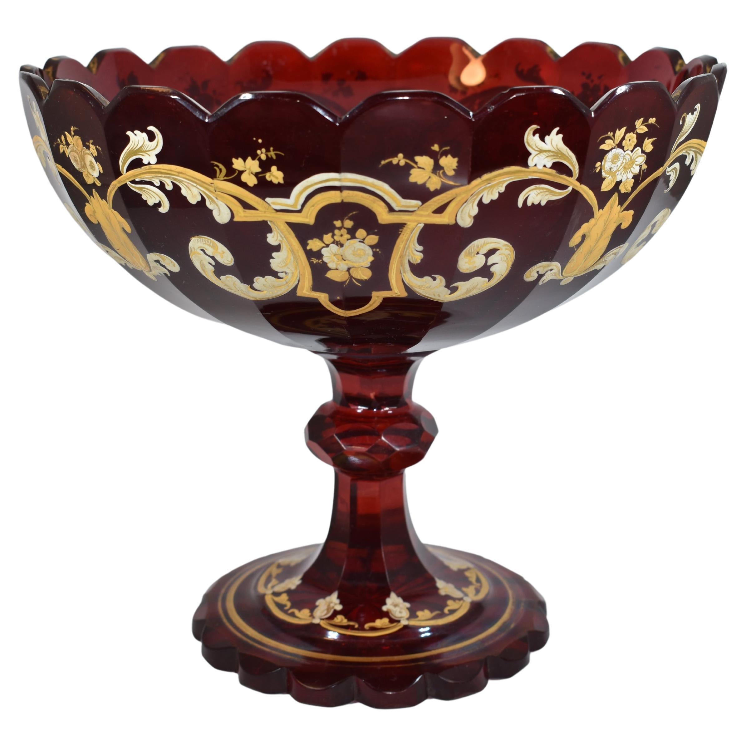 Stunning tazza bowl in deep transparent ruby red glass with scalloped rim

profusely decorated with 2-colored gilded enamel featuring scrollwork symmetric patterns, flowers and leaves

scalloped foot cut with a star pattern