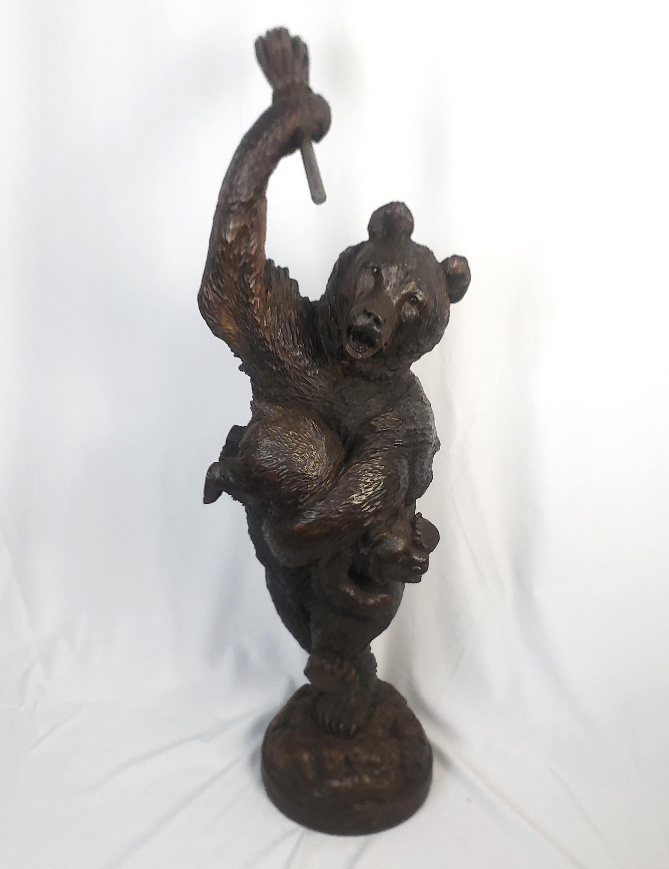 This sizeable antique folk art carving is unsigned, but presumed to have originated from the Brienz area of Switzerland and date to approximately 1880 and done in the period Black Forest style. The carving is done in pine and depicts and standing