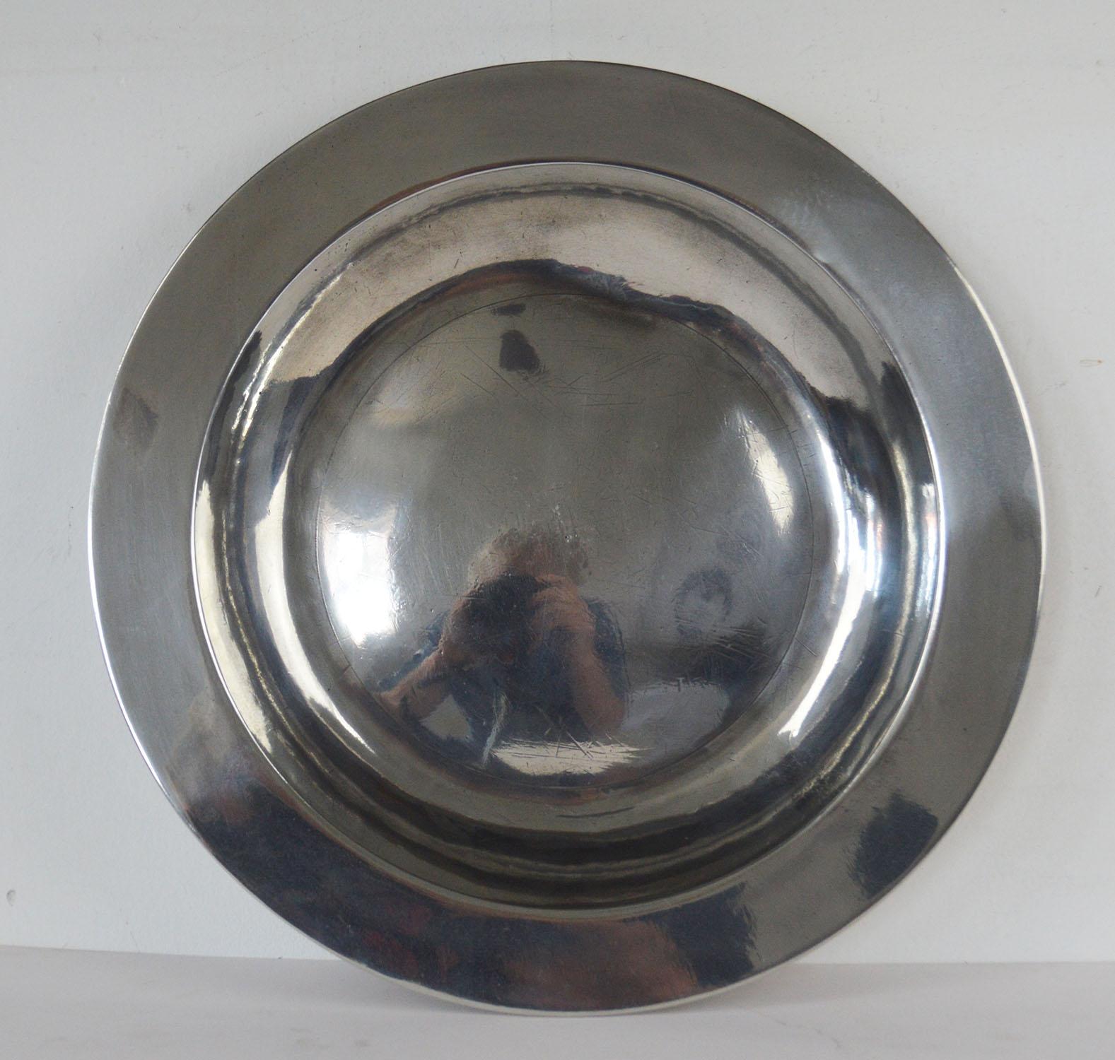 Wonderful highly polished dish. Measures: 13 inches.

English, late 18th century

The pewter has been polished to its original shine to imitate polished silver. It was known as the poor man's silver.

Rubbed touch marks on the underside.