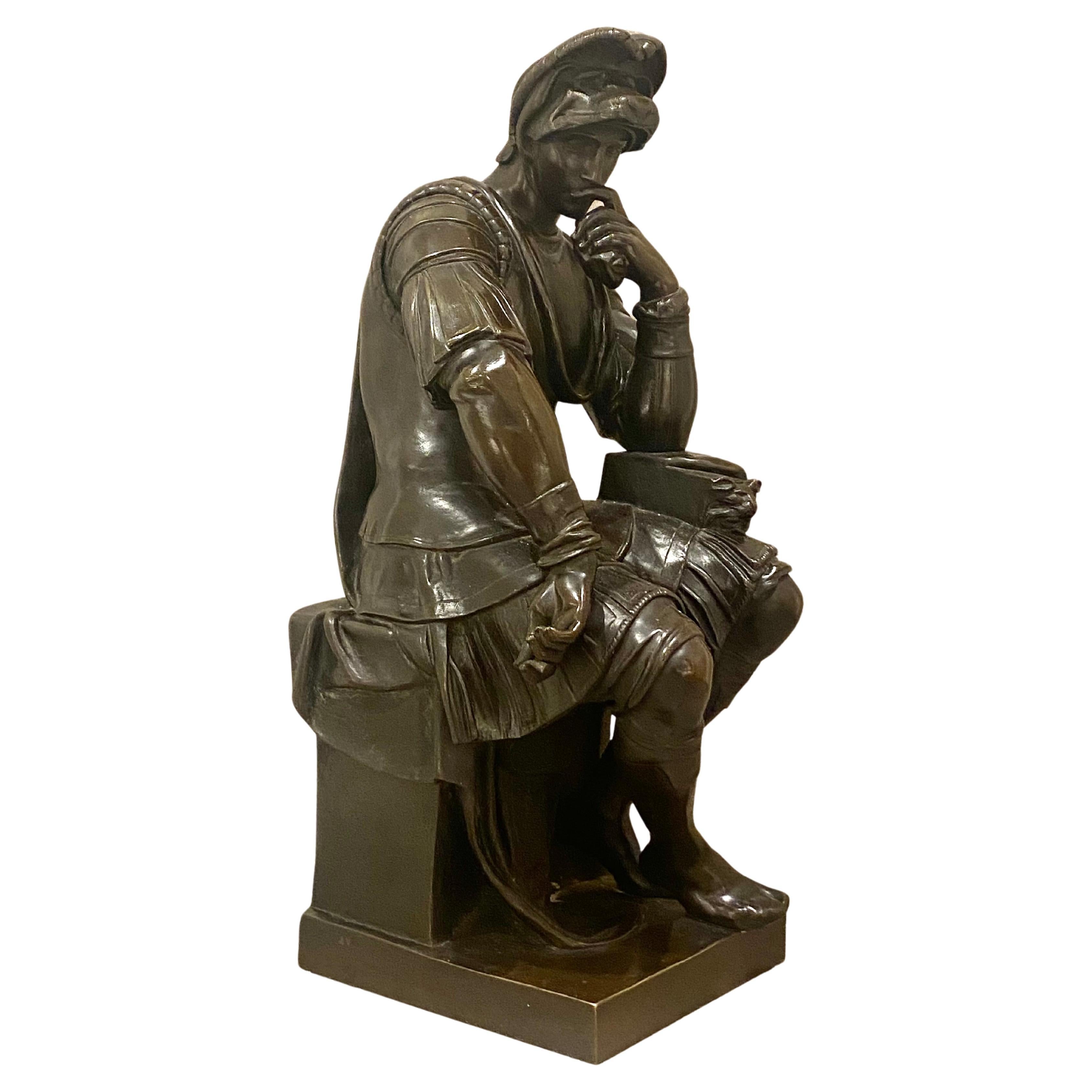 A Large late 19th century patinated bronze statue of Michelangelo's seated thinker from the tomb of Lorenzo de Medici, Duke of Urbino in Florence. The original circa 1525. Stamped on the side and 