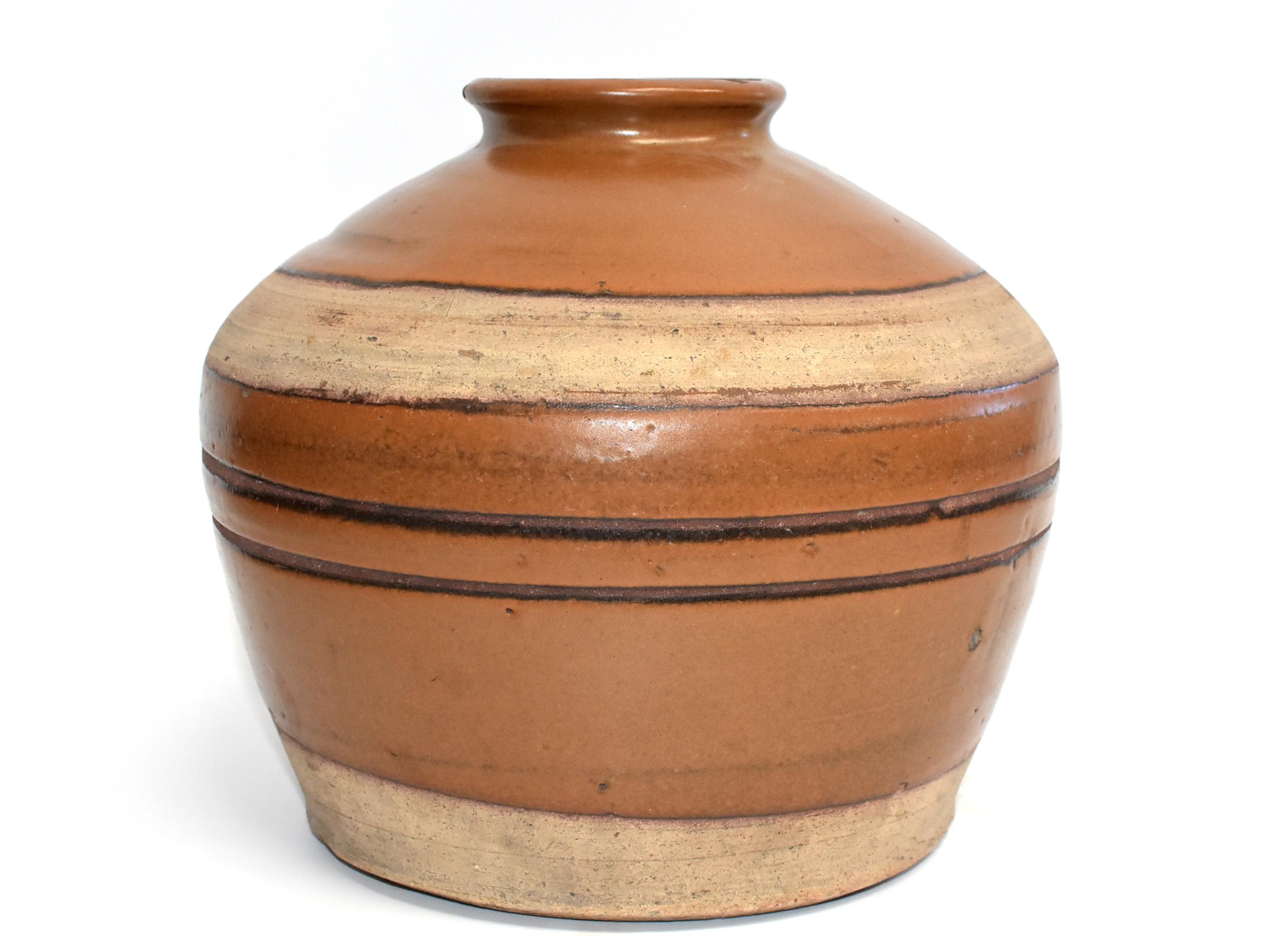This wonderful piece is from Shan Xi province, an ancient state of China. The area is famous for producing rich, aromatic, dark vinegar. Historically these jars were used to store the prized liquids. Their rustic, artistic appeal with the beautiful