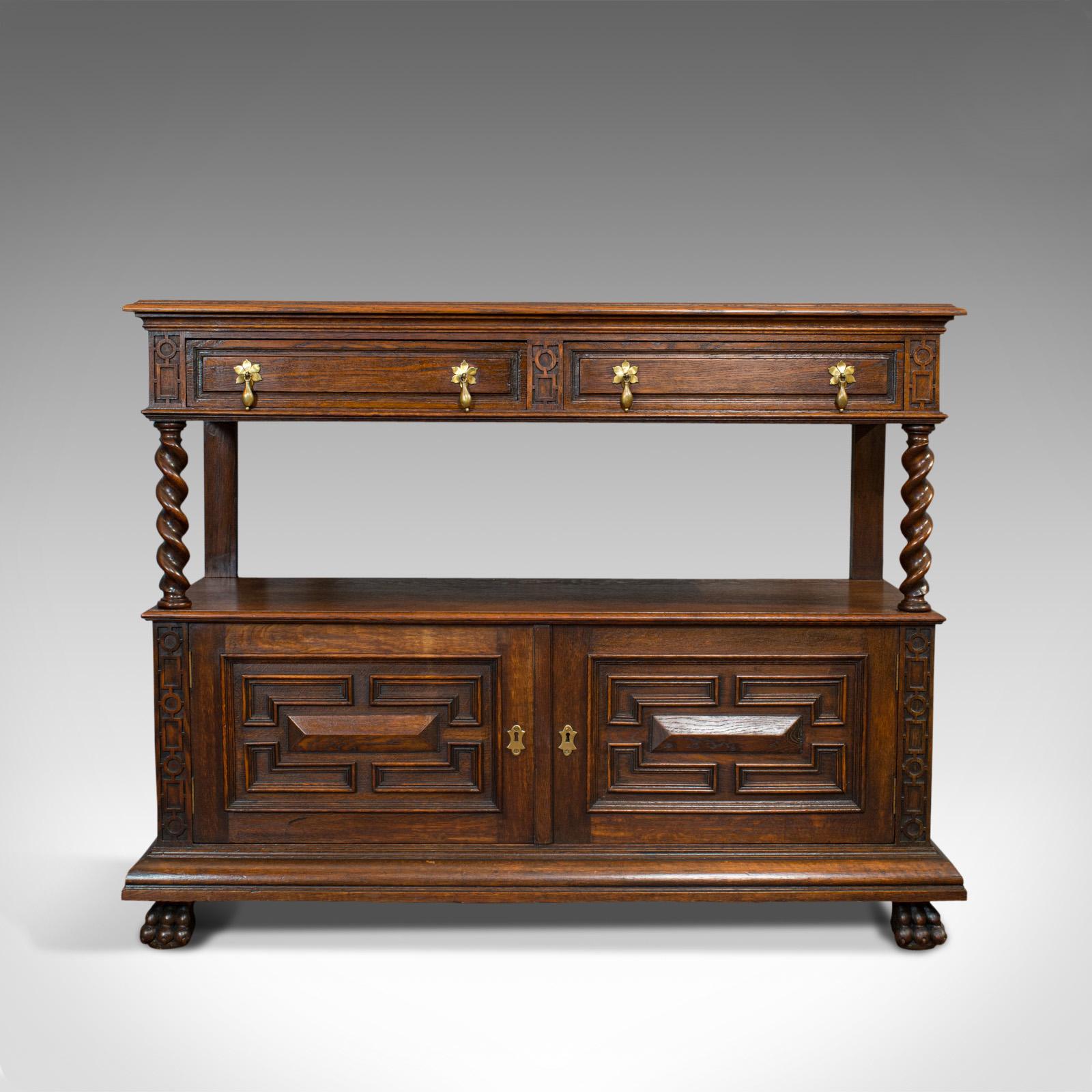 This is a large antique buffet. An English, oak server or sideboard in Jacobean revival taste, dating to the late Victorian period, circa 1880.

Classic buffet with striking detail
Displays a desirable aged patina
Oak stocks shows fine grain