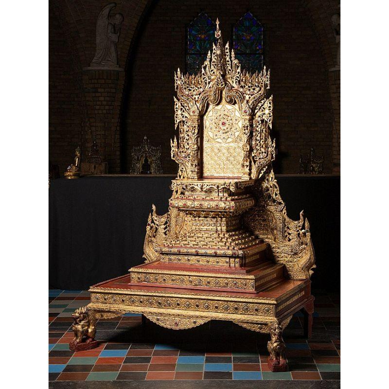 Material: wood
Measures: 203 cm high 
136 cm wide and 92 cm deep
Gilded with 24 krt. gold
Mandalay style
Originating from Burma
19th century
10 different parts - can be shipped worldwide !
A very rare and special throne !
The Buddha on the