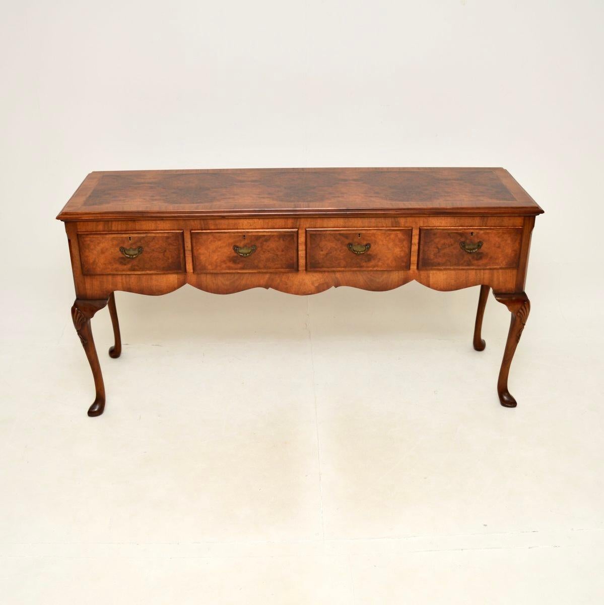 A stunning and large antique burr walnut console table. This is in the Queen Anne style, it was made in England and dates from around the 1900-1910 period.

It is of superb quality, with beautiful crisp carving on the legs and gorgeous burr walnut