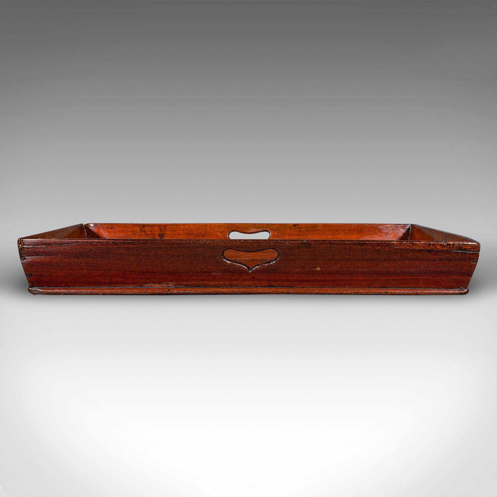 
This is a large antique butler's polishing tray. An English, mahogany serving tray, dating to the Georgian period, circa 1800.

Generously sized and with appealing, deep sides
Displays a desirable aged patina and in good order
Select stocks present