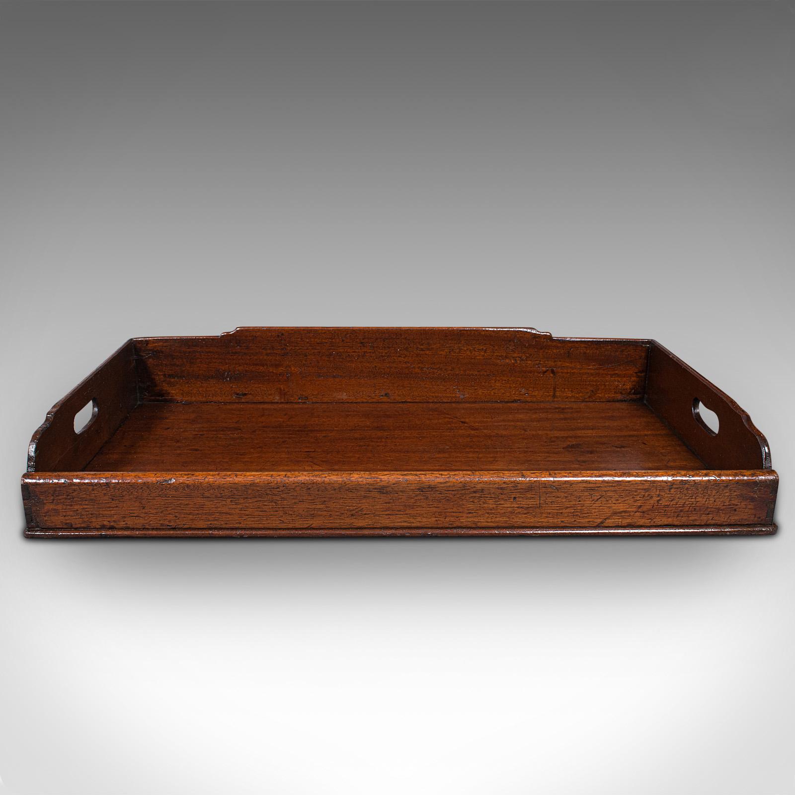 This is a large antique butler's tray. An English, mahogany tea service tray, dating to the Georgian period, circa 1800.

Pleasingly sized example with appealing antique charm
Displaying a desirable aged patina and in good order
Select stocks
