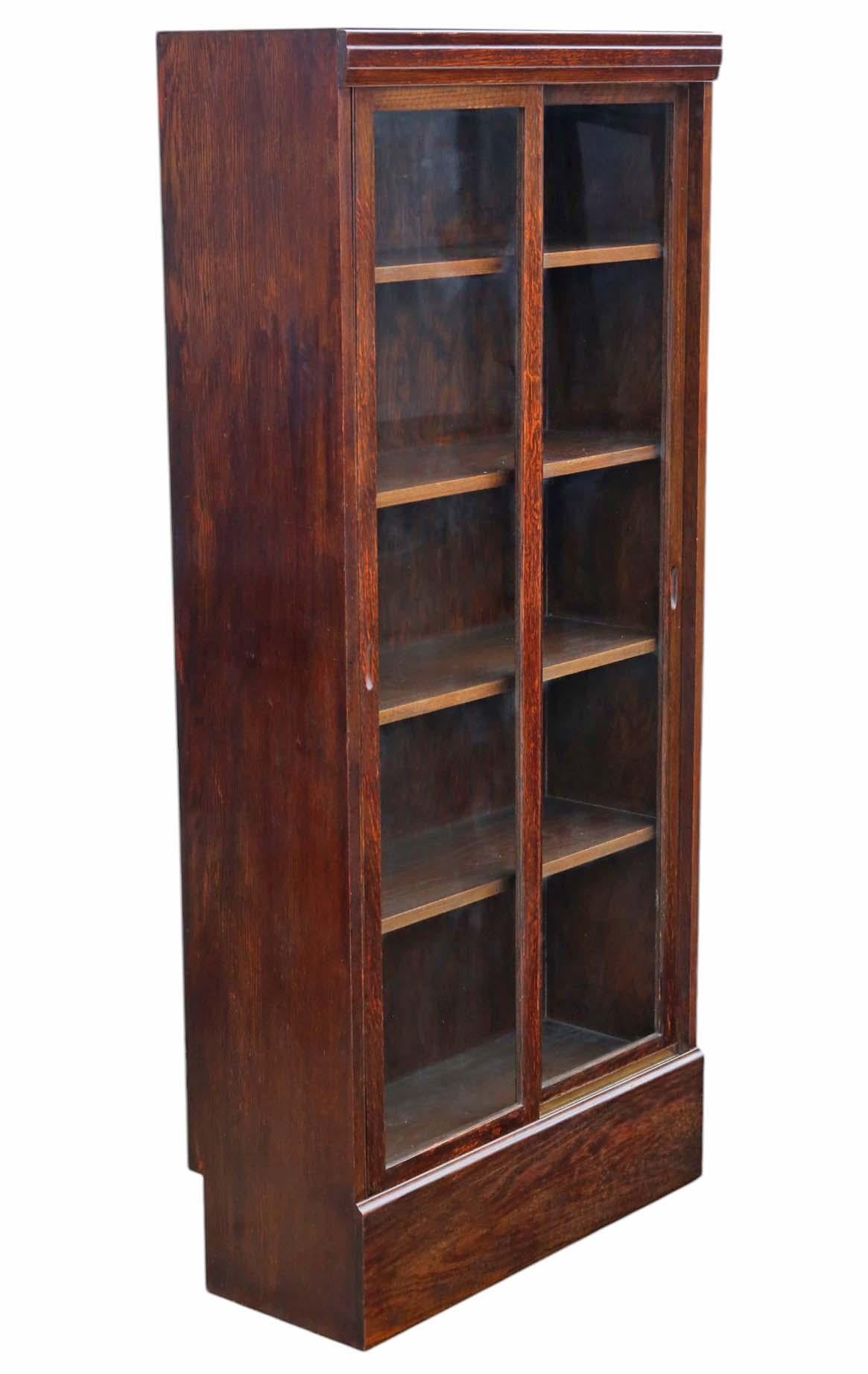 Large Antique c.1925 Oak Bookcase – High-Quality Shop Display Cabinet with Sliding Glass Doors

This beautifully crafted oak bookcase, dating to around 1925, boasts exceptional quality and a timeless, clean design. Rich in age, charm, and character,