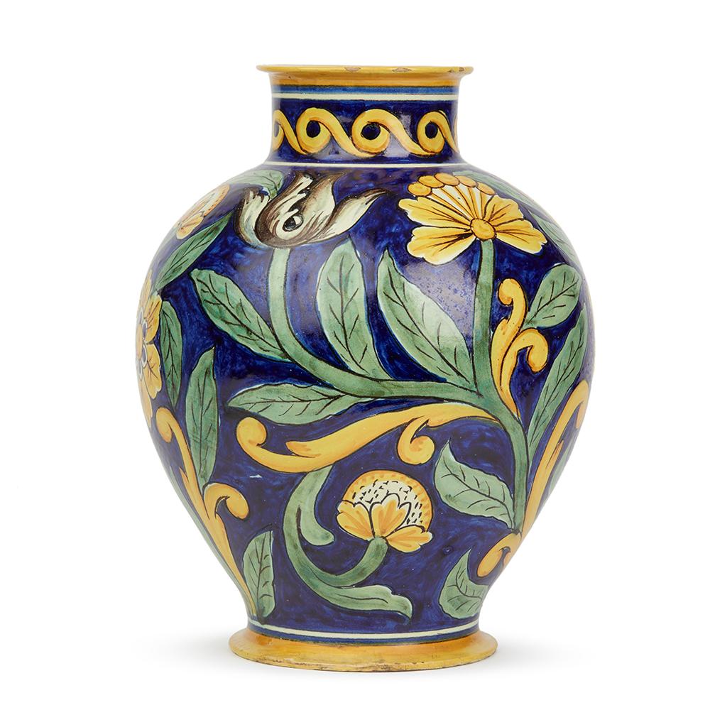 A stunning and large antique Italian rounded globular pottery Maiolica vase hand painted in bright colors with floral designs by Cantagalli. The vase is decorated in yellow and green with black outlines on a blue ground and reflects the revival of