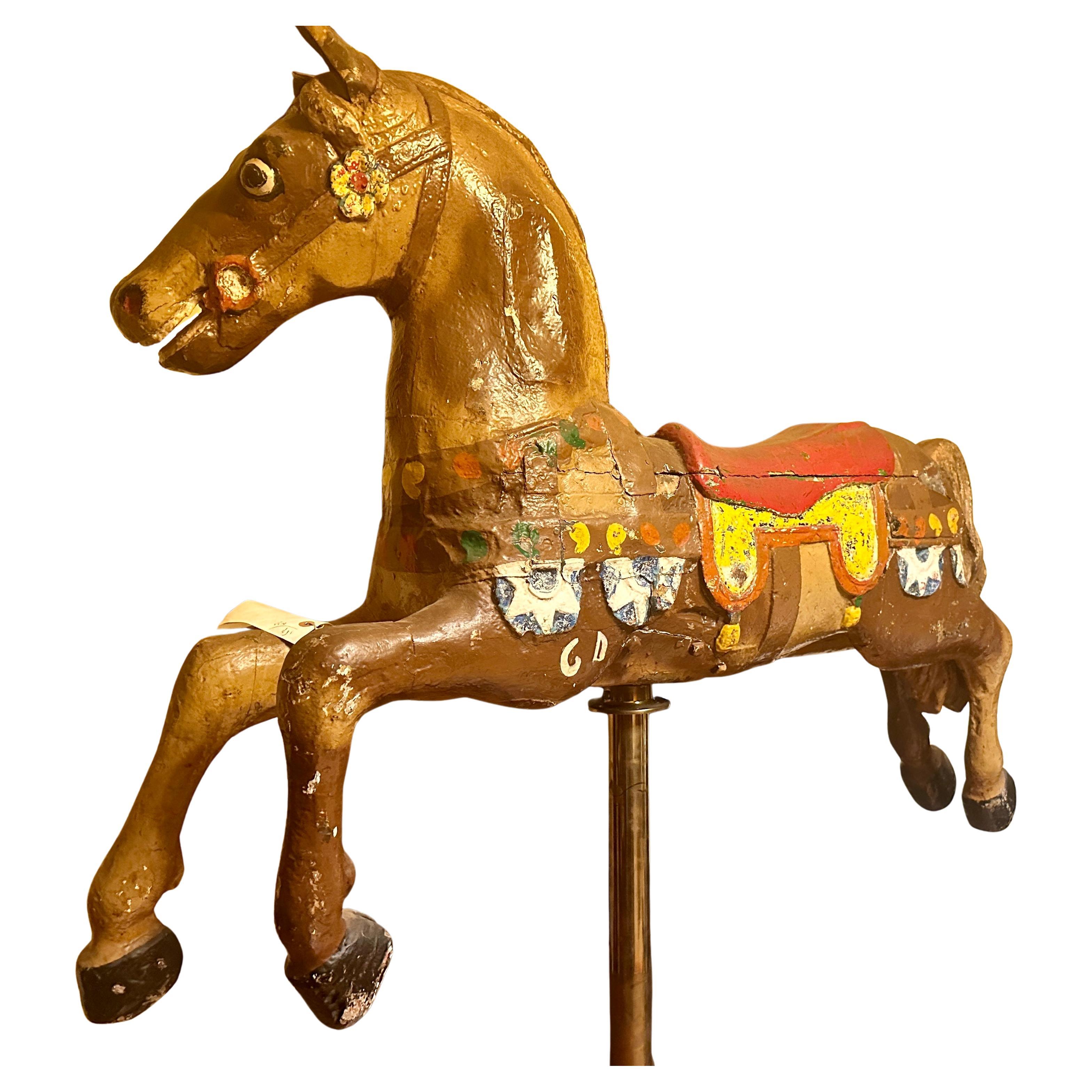 This is a great Carousel Horse that came from an estate in Buffalo, NY. It was made in the early 1900s and is in good condition. The horse is sitting on a metal pole made by a person who made them for Hollywood productions. The pole is 80 inches