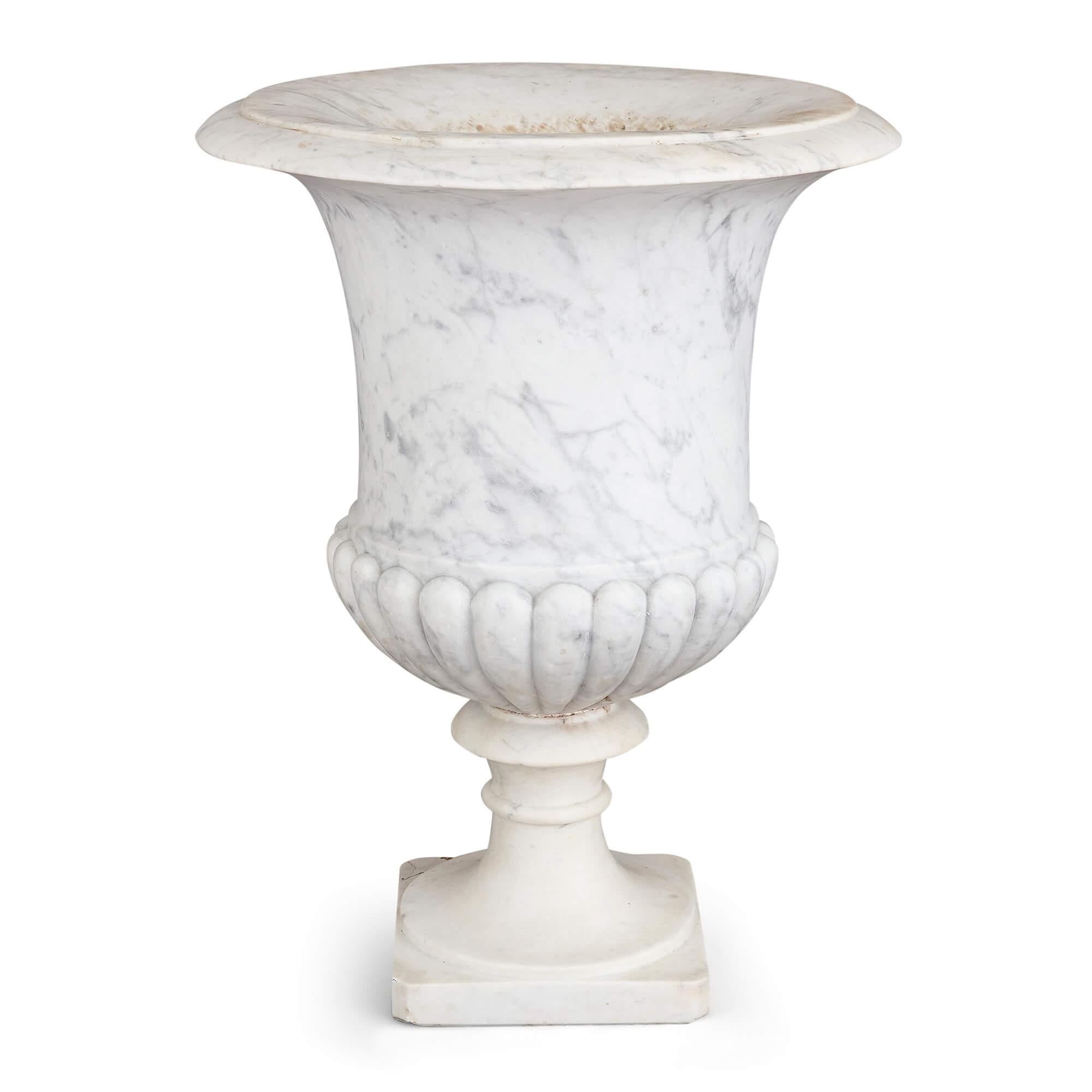 Large antique carved white marble Medici vase garden urn 
Continental, 20th Century
Height 73cm, diameter 55cm

Crafted in the 20th century, this radiant white marble garden urn emanates an aura of timeless elegance. Drawing its aesthetic