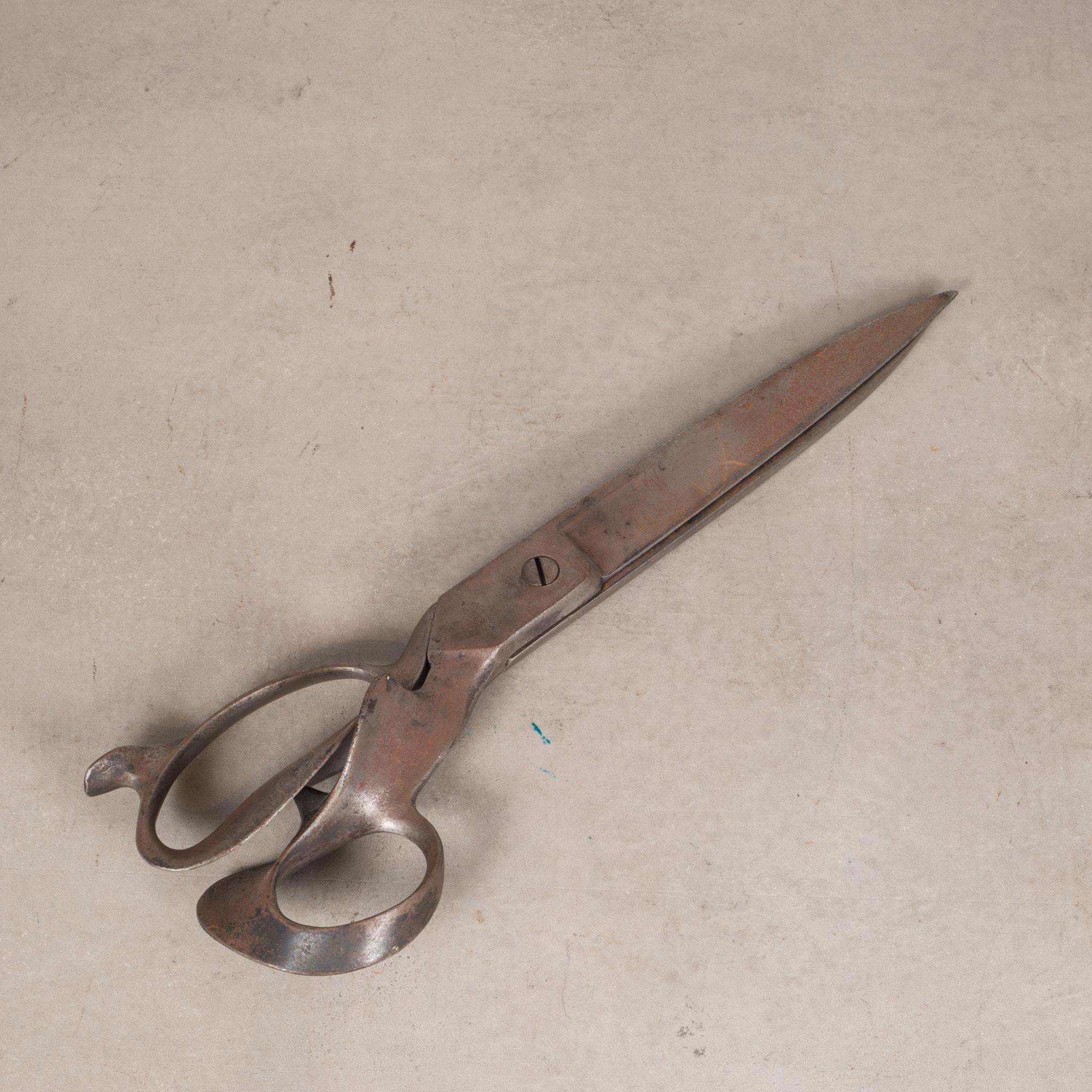 ABOUT

A pair of large cast iron upholstery shears. The large pair has brass couplings.

 CREATOR R. Heinisch, New York, A. Eichoff, New York.
 DATE OF MANUFACTURE c.1920s. 
 MATERIALS AND TECHNIQUES Cast Iron, Brass. 
 CONDITION Good. Wear