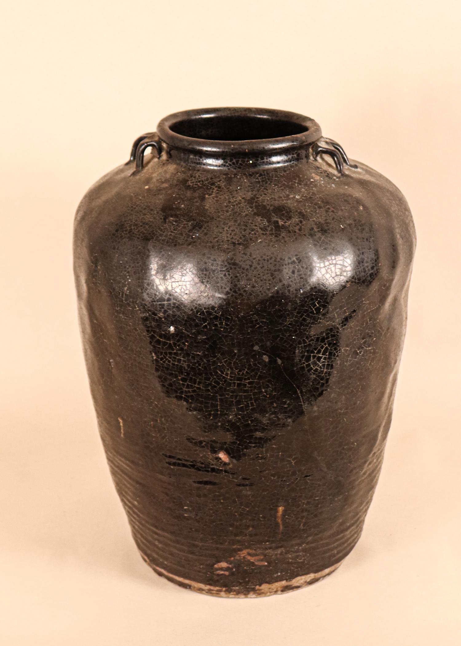 A large, hand built ceramic pot from Kerala, India, circa 1850. This stoneware vessel has a dark black-brown lead glaze with a beautiful, earthen patina. The jar is a perfect marriage of form and function. It was originally used for personal water