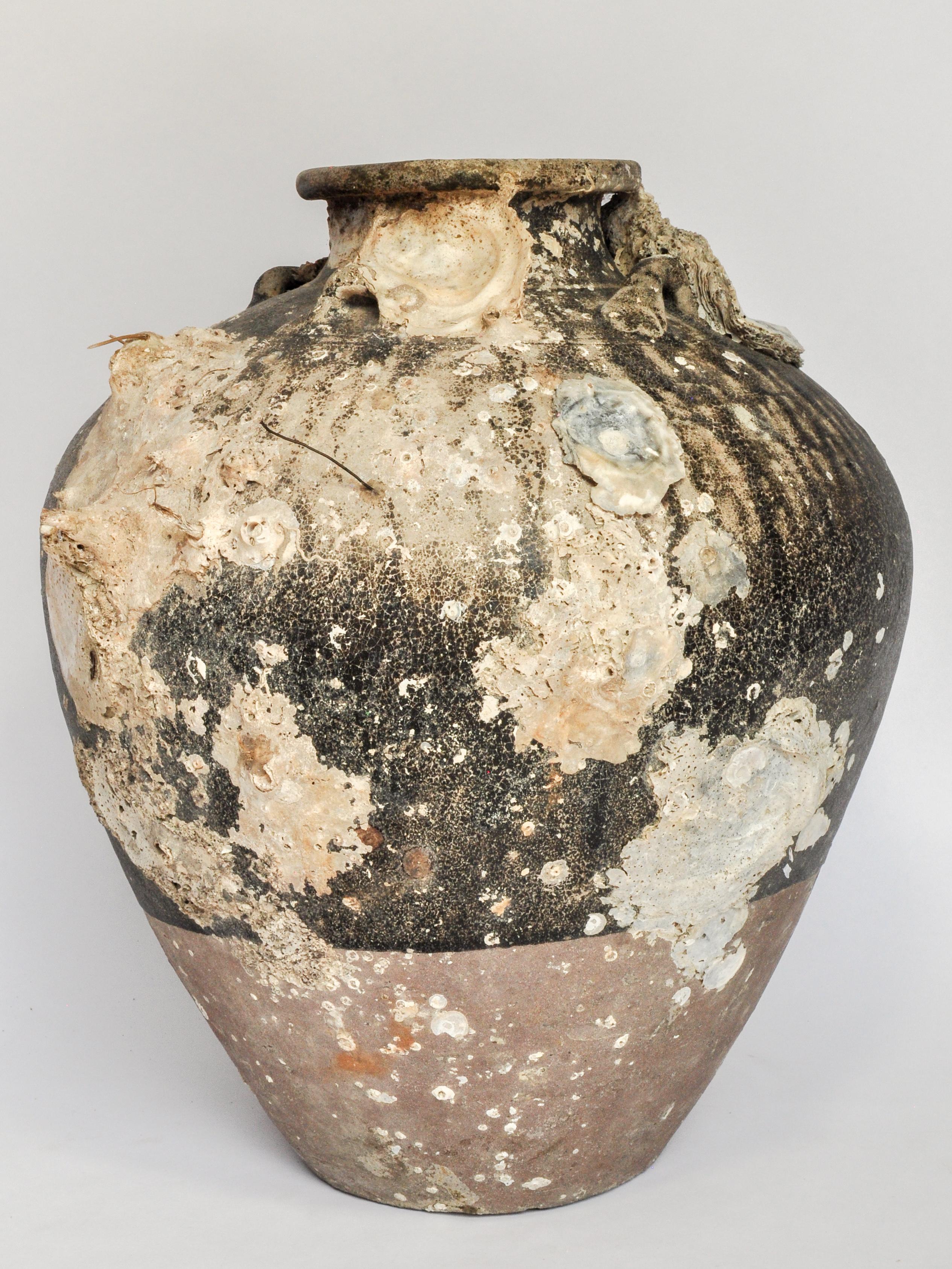 Large antique ceramic jar with encrustations Sawankhalok Thailand 14th to 15th century. 16