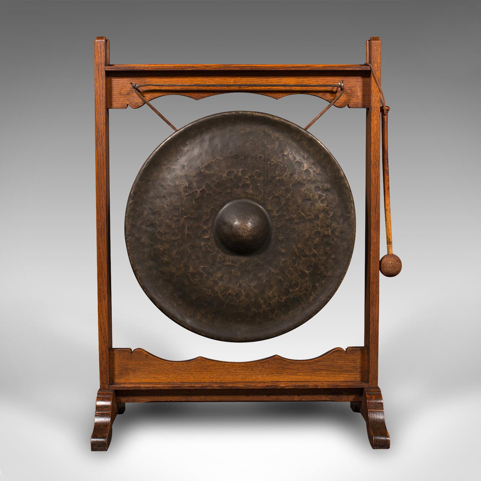 This is a large antique ceremonial dinner gong. An English, oak and bronze framed chime, dating to the late Victorian period, circa 1900.

Generously sized dinner gong within a quality frame
Displays a desirable aged patina and in good