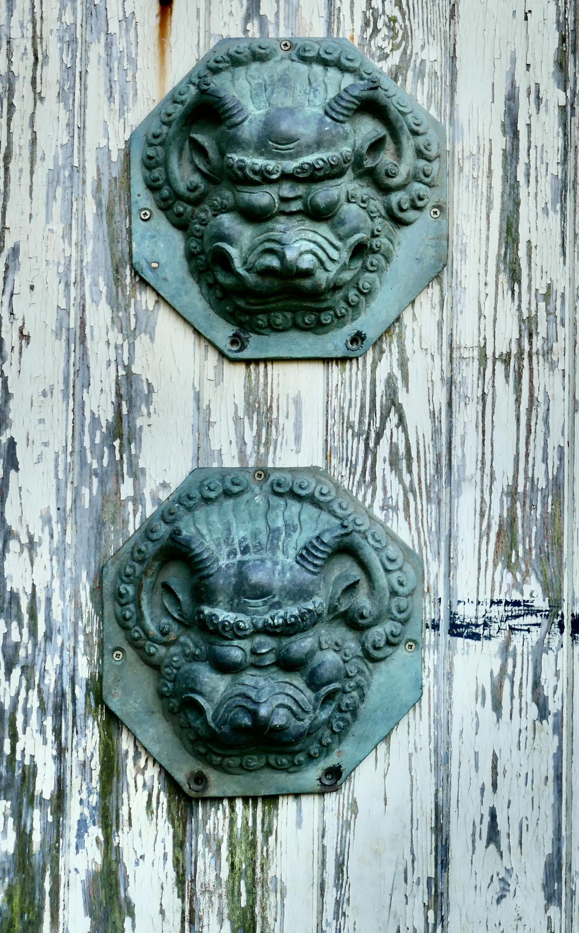 Large antique Chinese bronze foo dog foo lion door plates

A stunning pair of door plates, they are made in bronze and are very heavy, these may originally have had handles through the holes near the mouth

Aged with no faults the plates are