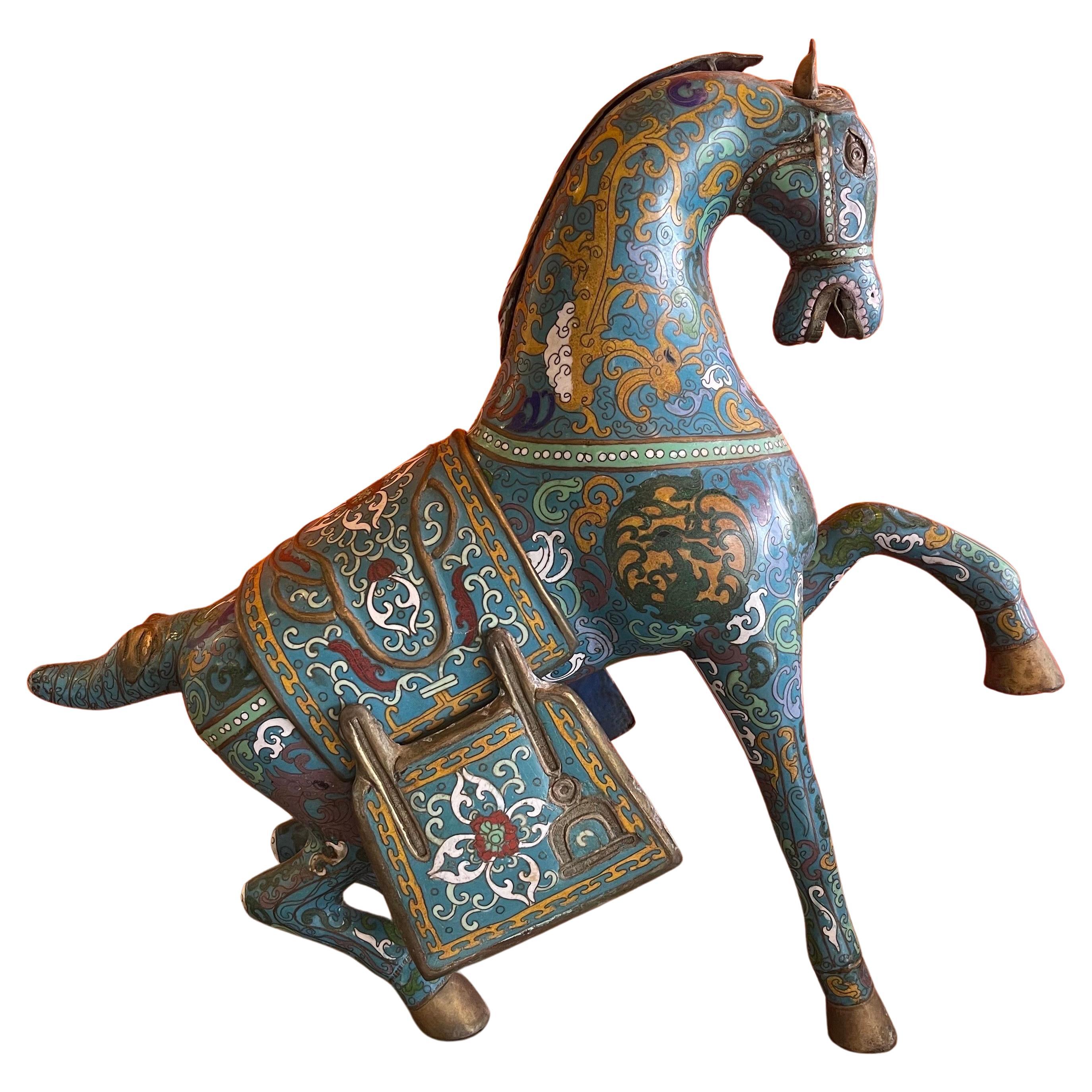 Large antique Chinese cloisonné Tang horse sculpture, circa 1940s. The piece is substantial in size and is decorated in colorful mythical theme patterns with detachable saddle and mane. The cloisonné work is enameled predominantly in old blue while