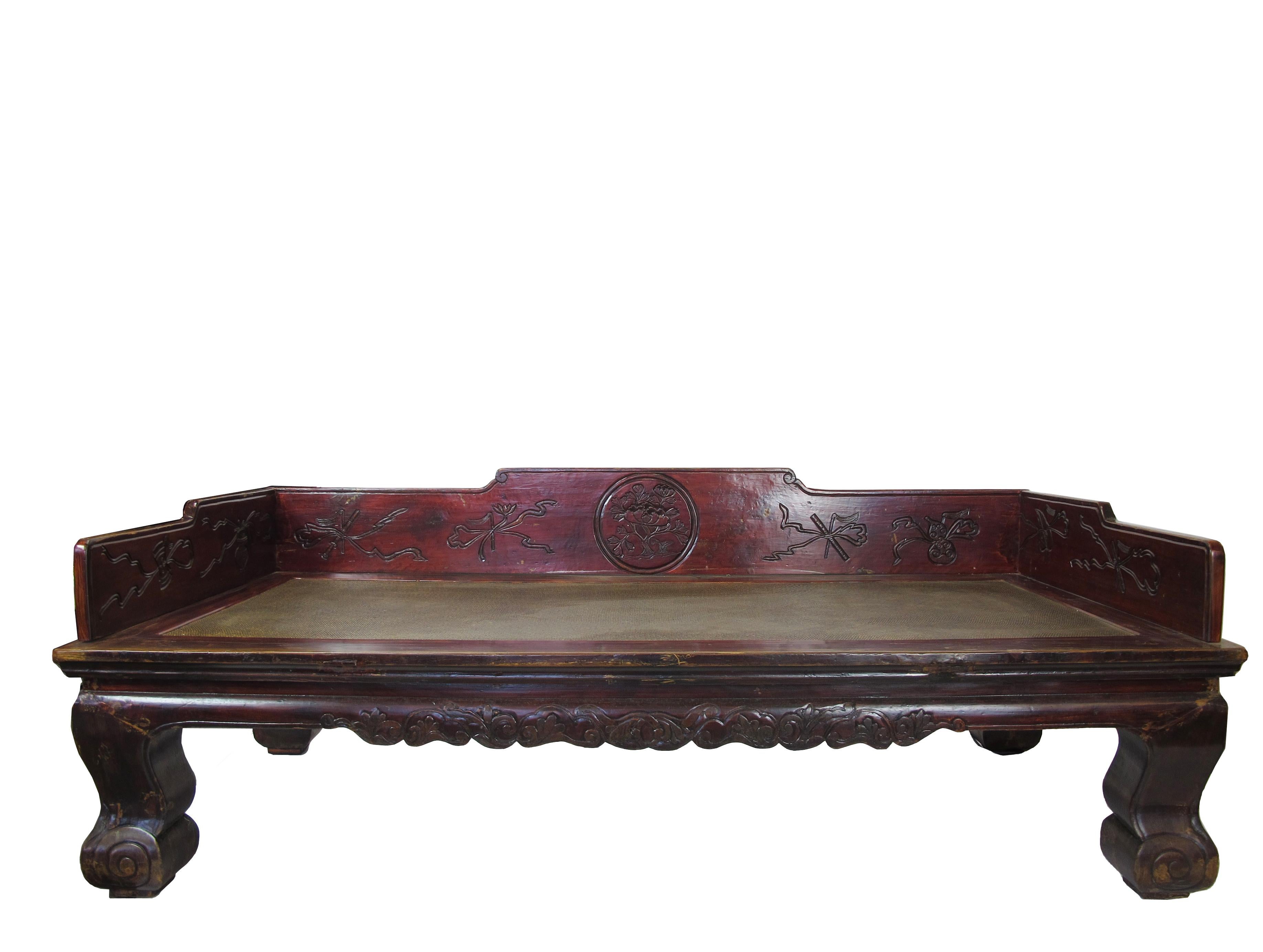 This large authentic antique Chinese daybed is also known as Luohan bed or Opium bed. The rails and frames are crafted from single planks of wood (no seams). Simple and elegant carving adorn inside of the rails and front strip. The scrolled legs