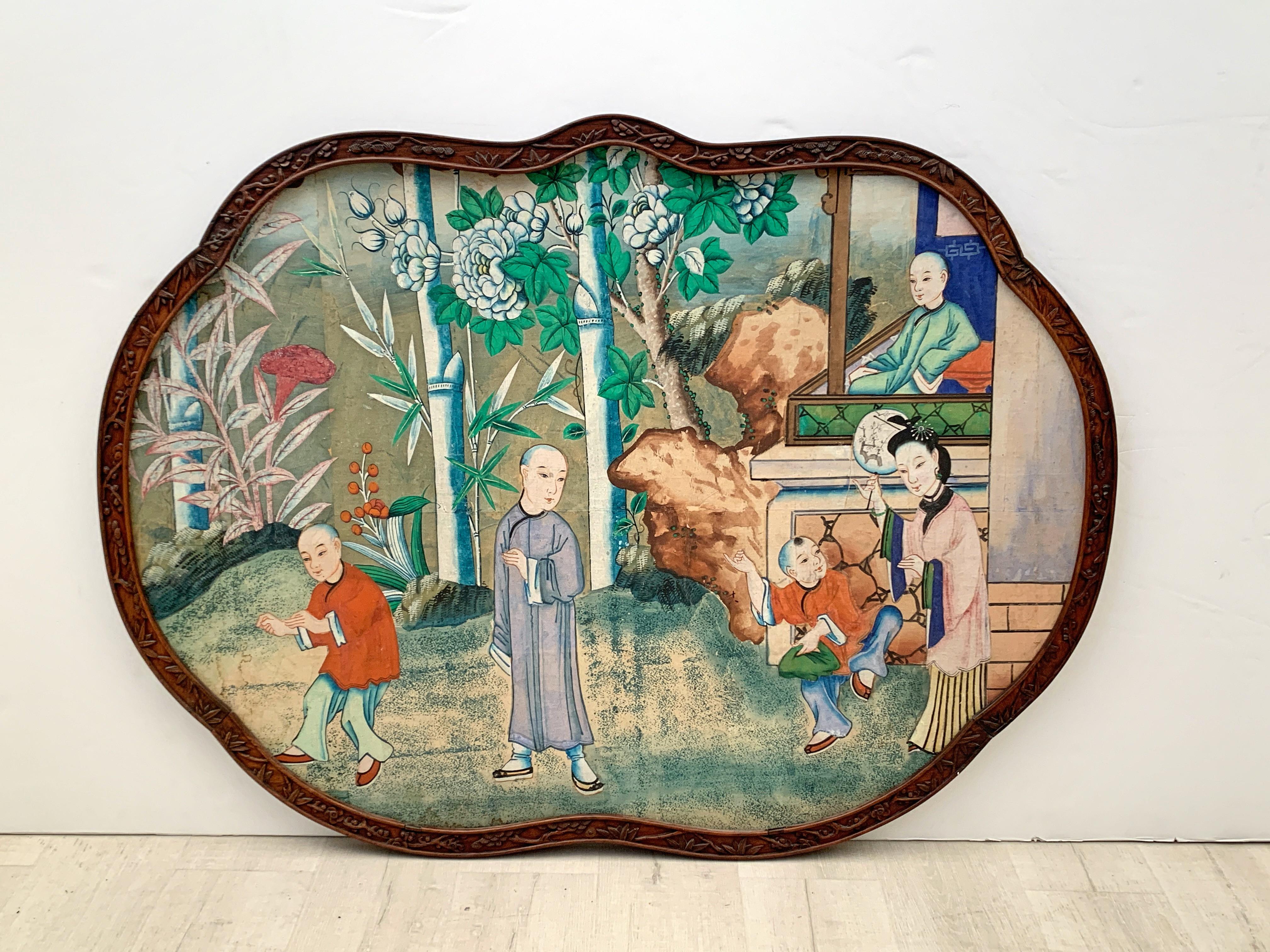 A wonderfully charming large and colorful Chinese hand painted wallpaper section in a carved and shaped hardwood frame. The wallpaper dates to the first half of the 20th century or earlier. The frame late 19th or early 20th century. The whole put