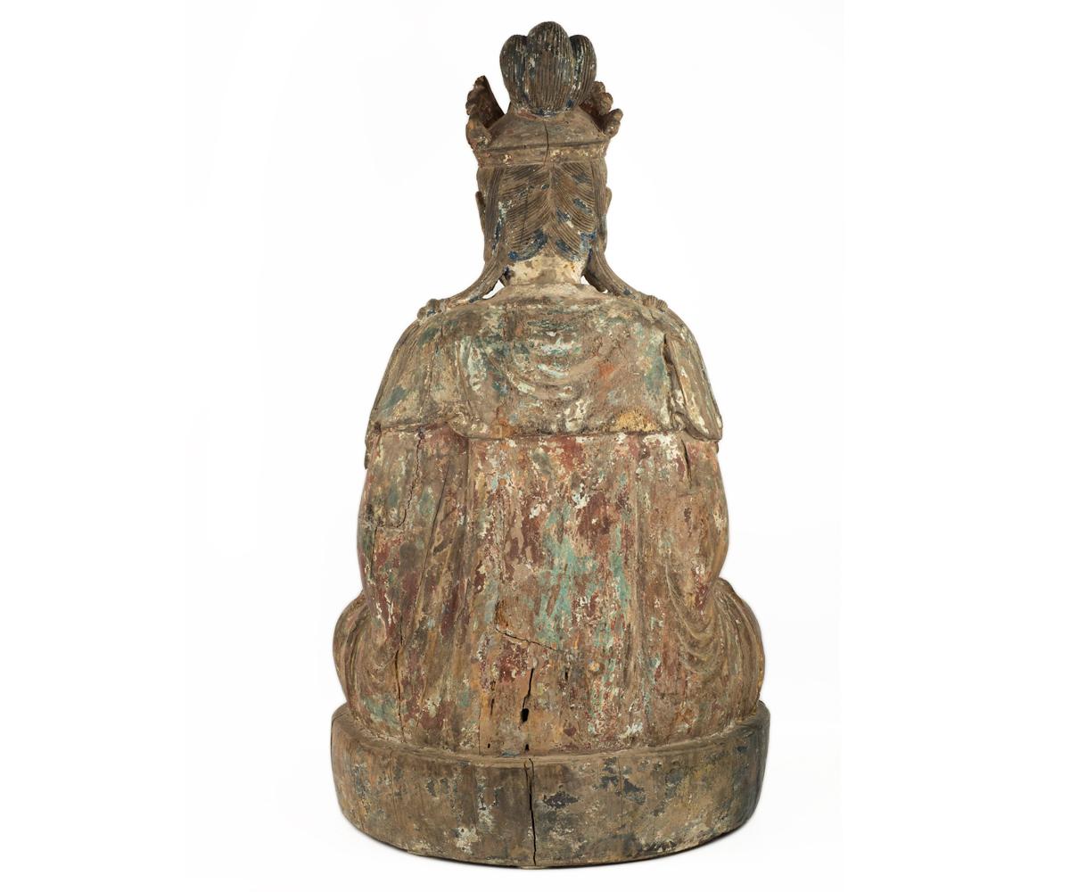 Offered is this large well preserved antique Ming dynasty Quan Yin (Guanyin) seated in mediation with hands in the dhyana mudra position. She is draped in flowing robes and has her swept up into an elaborate crown featuring the ever present Buddha.