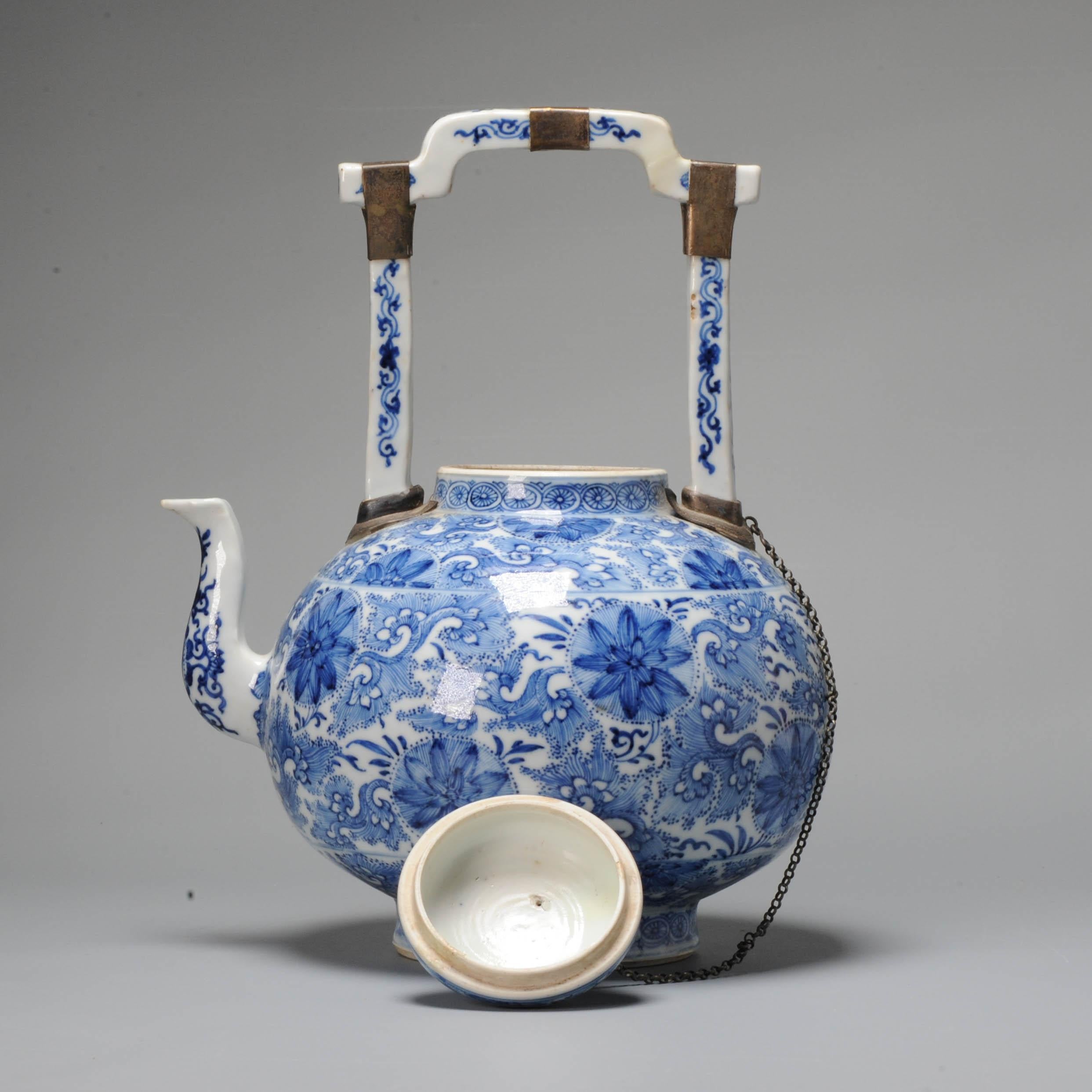 The large cobalt blue wine vessel with nice handle and beautiful decoration of flowers. The cobalt blue and painting quality are amazing to my humble opinion. A high quality and unusual piece from the Kangxi period. 2 concentric circles at te