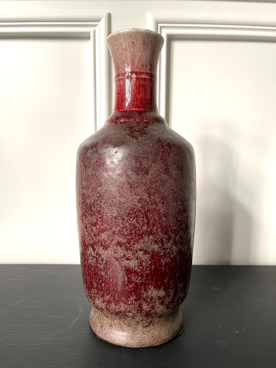 A large Chinese vase with Sang-de-Boeuf (oxblood) glaze in a classic baluster form with a tall narrow neck and horizontal bands around the shoulder. The oxblood glaze is known as Langyao Red in Chinese. It is a copper based glaze originated in Ming