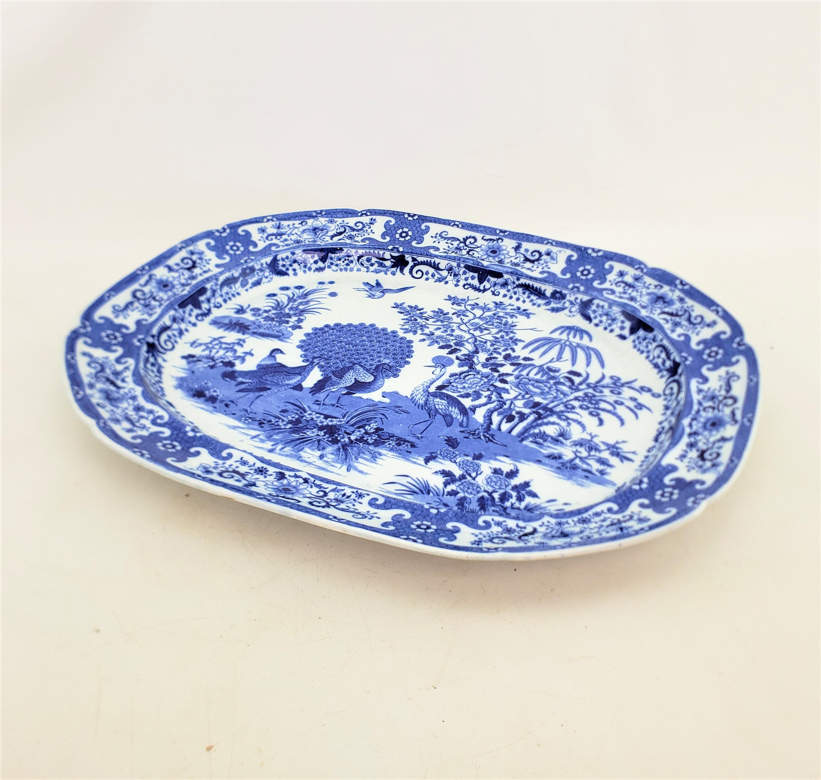 This large and substantial serving platter is unsigned, but presumed to have originated from England and date to approximately 1880 and done in the period Victorian style. The platter is composed of ceramic with a bright cobalt blue tranfer on the