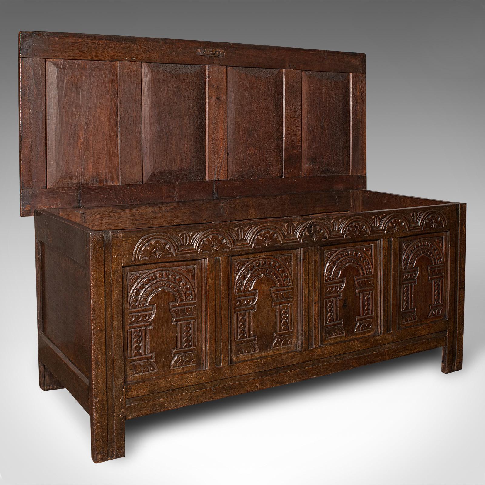 This is a large antique 4 panel coffer. An English, oak carved trunk or window seat, dating to the William III period, circa 1700.

Superb example with appealing carving and stout antique stocks
Displays a desirable aged patina and in good order
