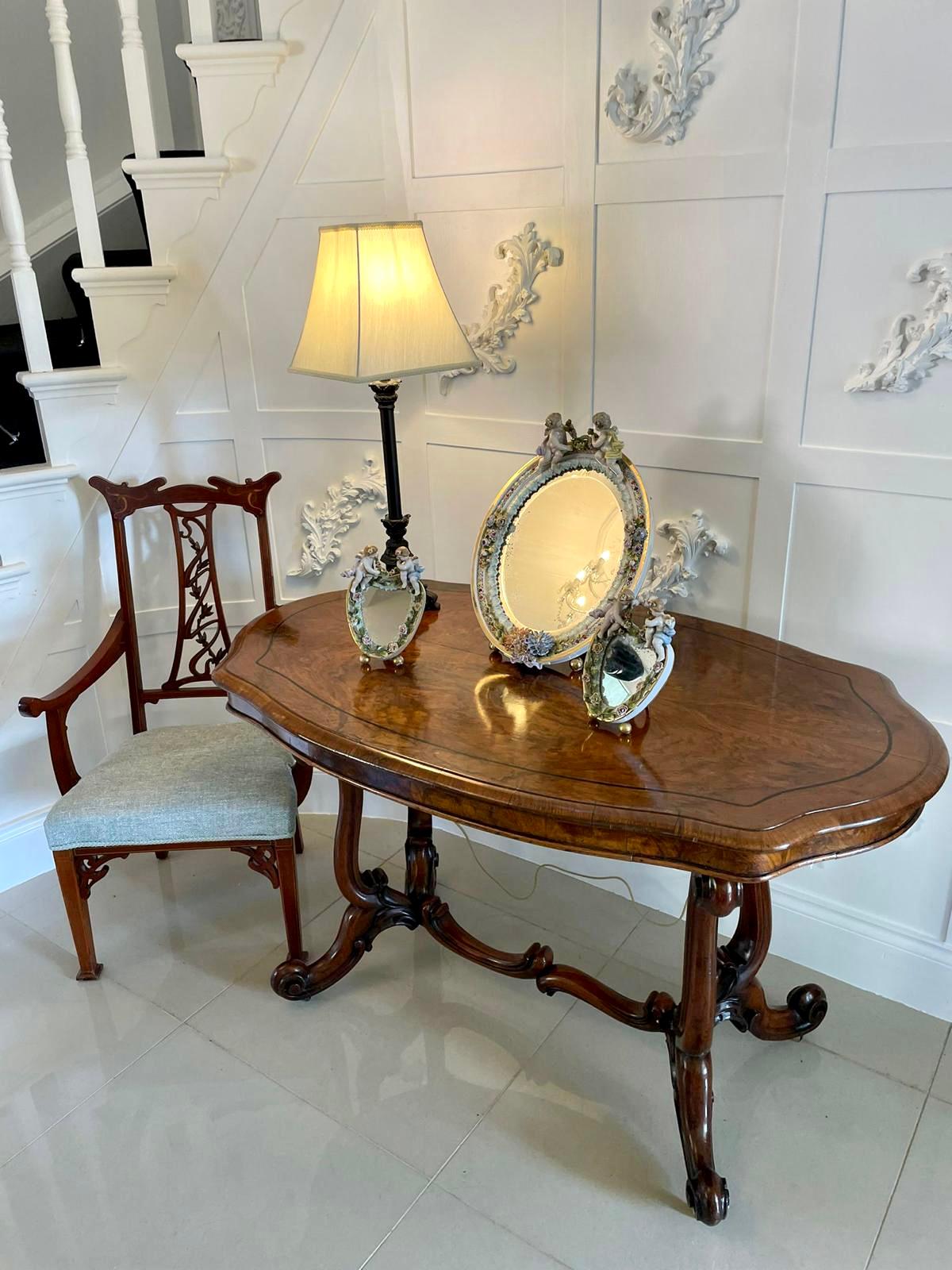 Large antique continental porcelain easel mirror with an oval mirror plate and foliate decorated edge surmounted by two cherubs. 

This is a charming piece in beautiful original condition.

The pair of porcelain heart shaped mirrors shown with