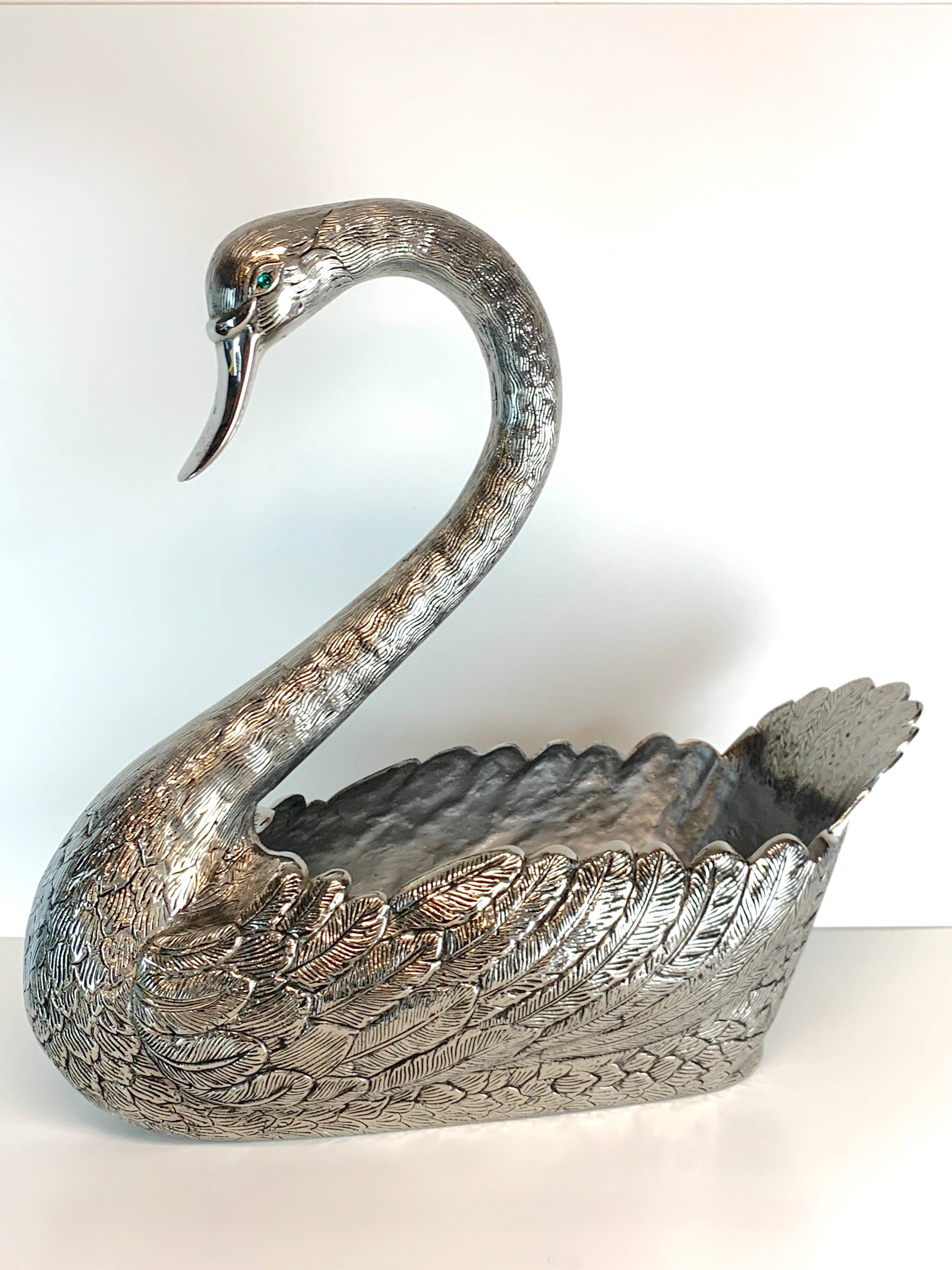 Large antique Continental silver plated swan centerpiece in the style of Buccellati, realistically cast and chased with inset green glass eyes, marked with numerous hallmarks, refer to photos. Standing 19-Inches high x 18-Inches wide x 7-Inches