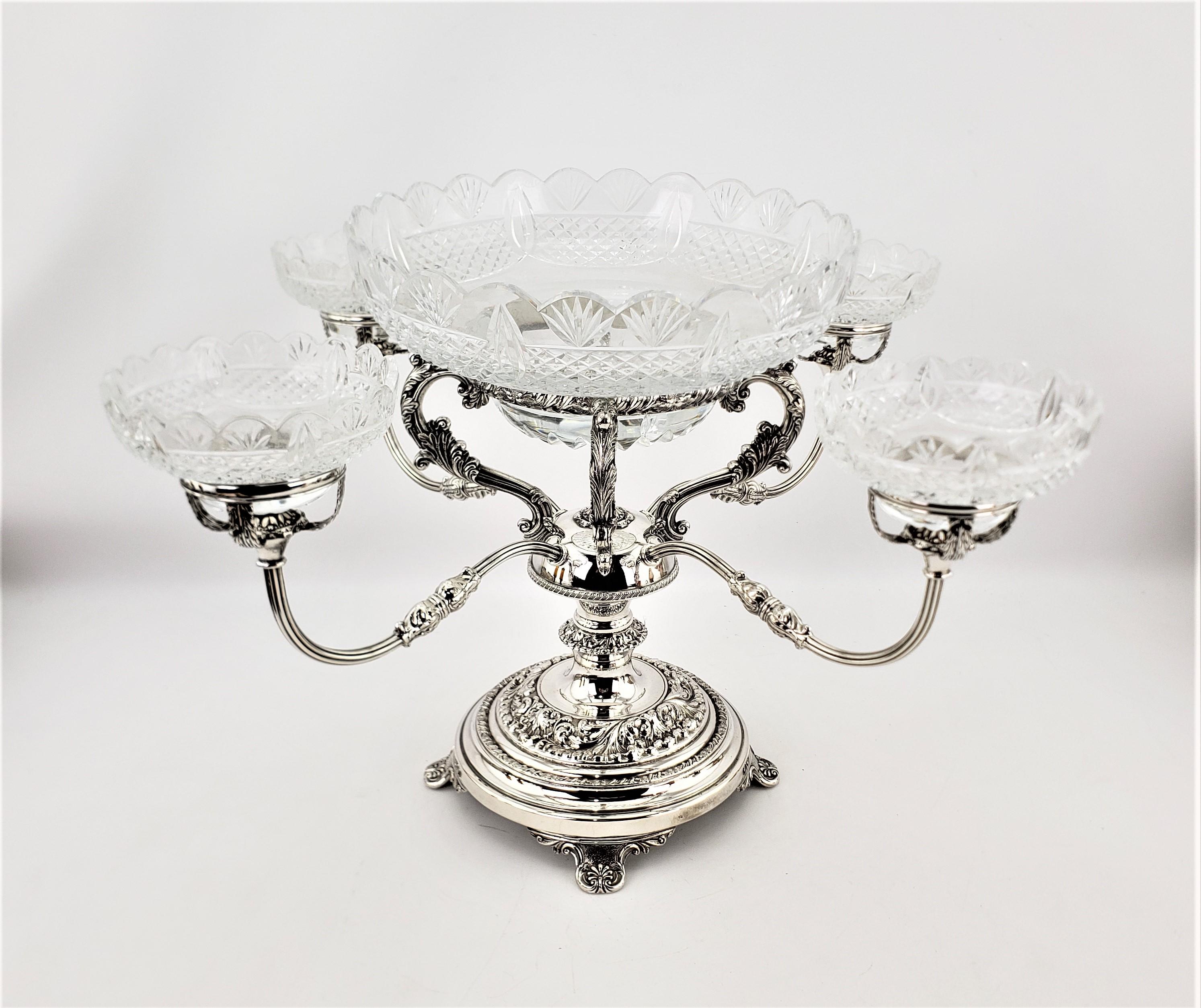 This large and imposing silver plated four arm centerpiece is unsigned, but presumed to have originated from England and dating to approximately 1900, being done in the period Edwardian style. This very well plated four arm convertible centerpiece