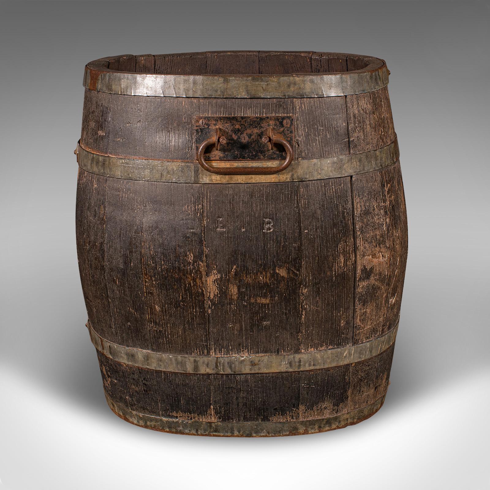 This is a charming early Victorian stick stand, offering classic country house appeal, circa 1850. Crafted with coopered oak staves and iron strap binding, this substantial umbrella stand or fireside store boasts a rich, time-worn