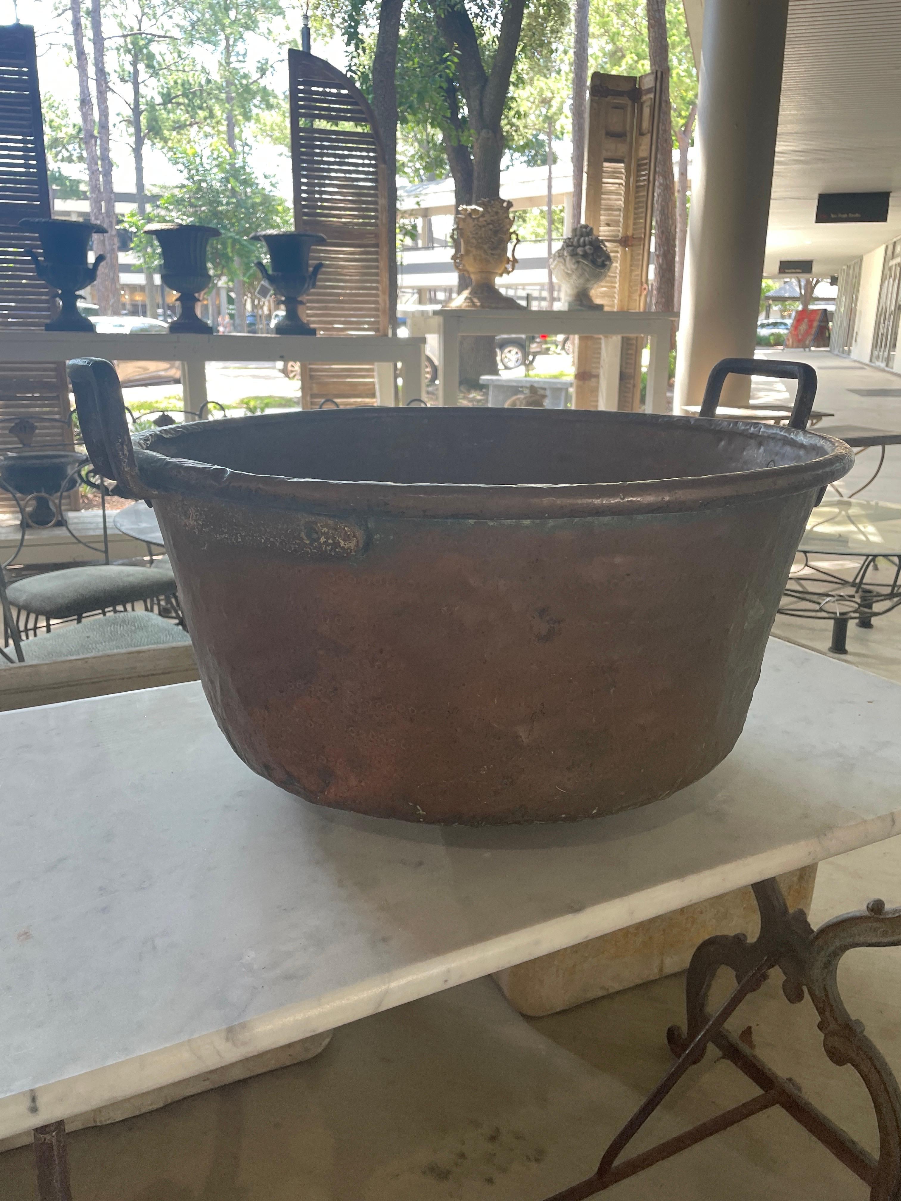 This antique copper mixing bowl is a timeless piece that exudes both elegance and functionality. Crafted decades ago by skilled artisans, its rich, burnished surface tells the tale of years of culinary creativity. With a generous capacity, it stands