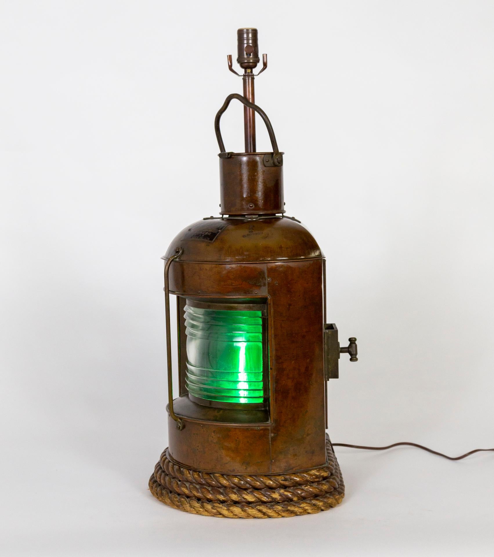 These lanterns were made in the early 20th century with excellent craftsmanship as ship lights for signaling and navigation.  They are newly made into table lamps with a stem and socket in a matching finish on top, and the original interior lights