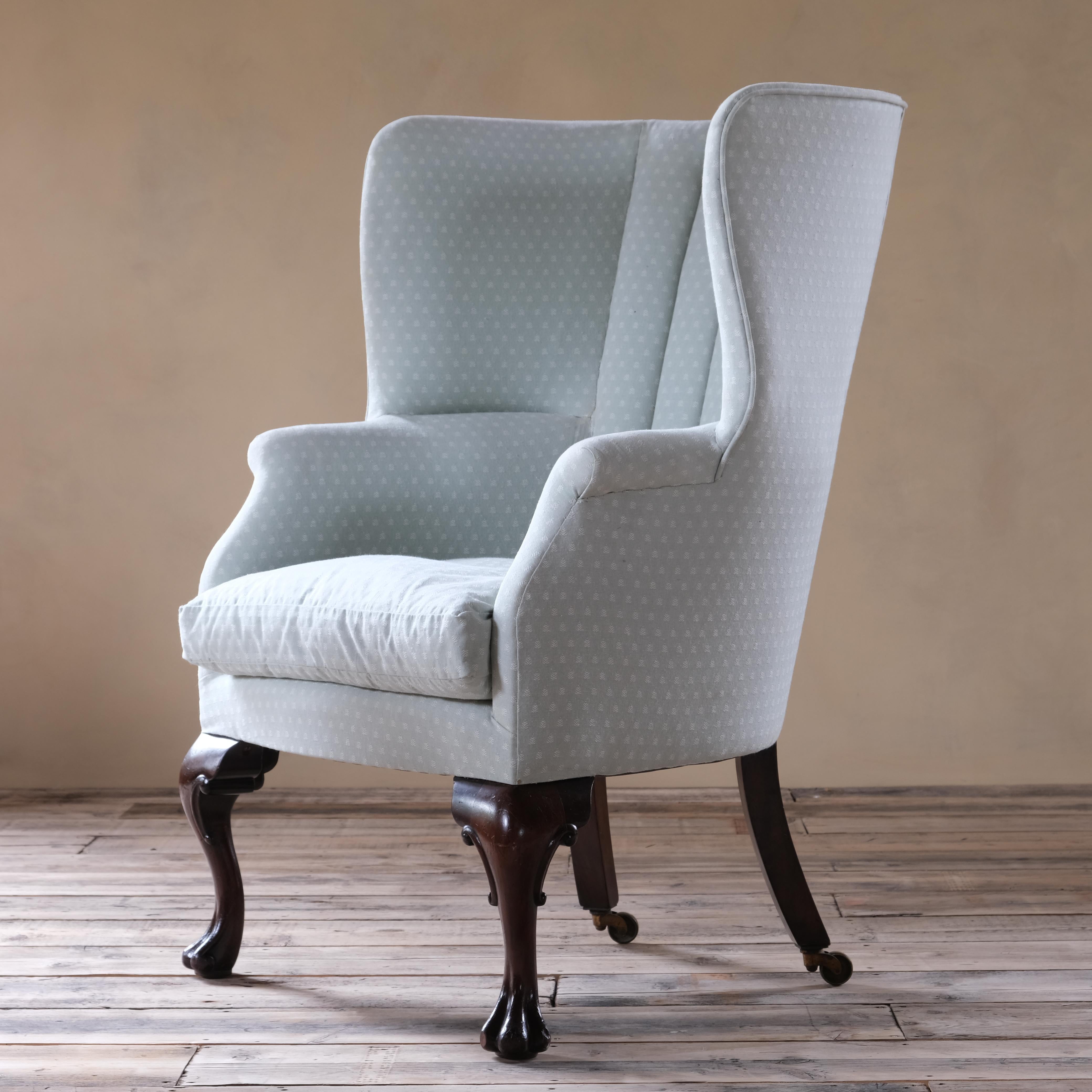 A large c1900 barrel backed armchair raised on large good quality carved cabriolet front legs and out splayed rear legs with Cope and Collinson brass casters. 

The pale blue fabric is recently done (not by us) and in very good condition, ready