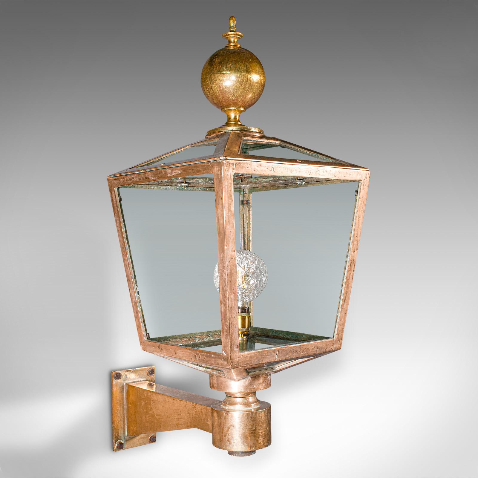 
This is a monumental antique courtyard light. An English, bronze and glass outdoor lamp fixture, dating to the Victorian period, circa 1870.

Strikingly substantial and impressive form, ideal for a country house residence
Displays a desirable aged