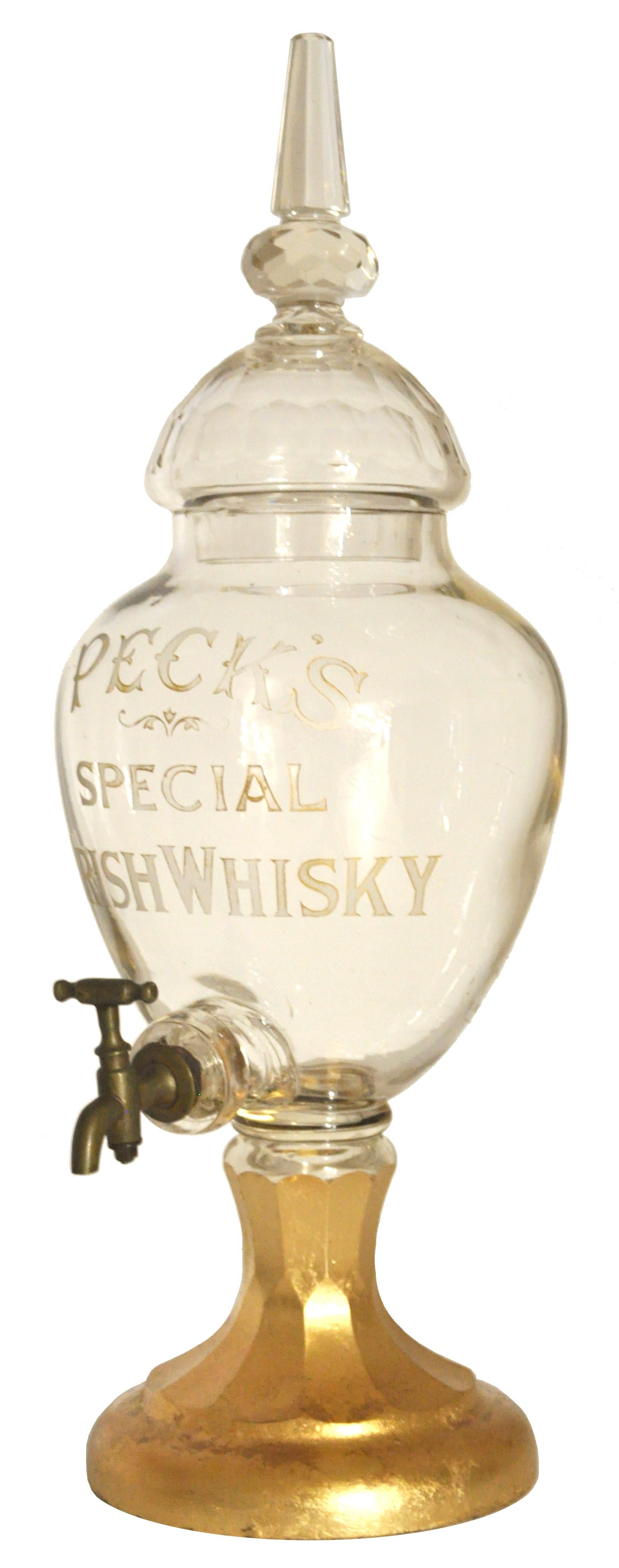 A rare and large, cut glass crystal Irish whisky decanter, circa 1870. The decanter having a faceted lid with a tall finial above a faceted knop, the body having a baluster shaped reservoir with the legend 